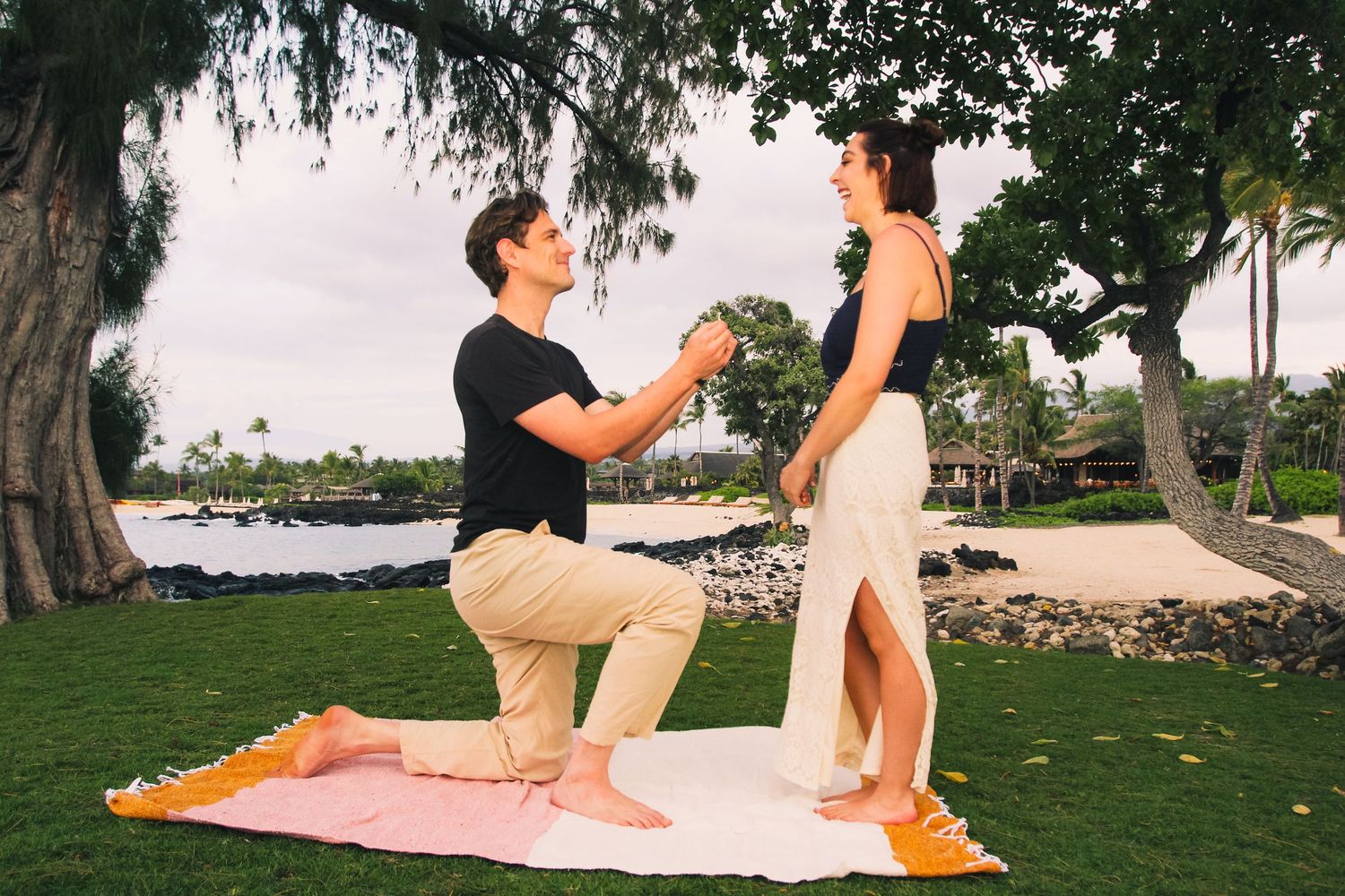 Surprise proposal moment on beach in Kona Hawaii at golden hour