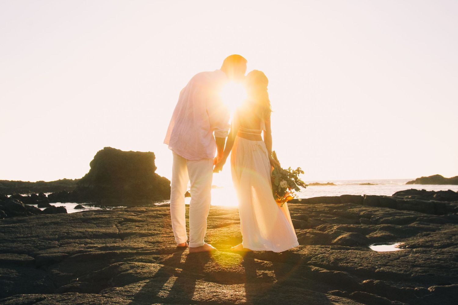 Four Seasons Hualalai sunset wedding couple kissing Big Island Hawaii photographer