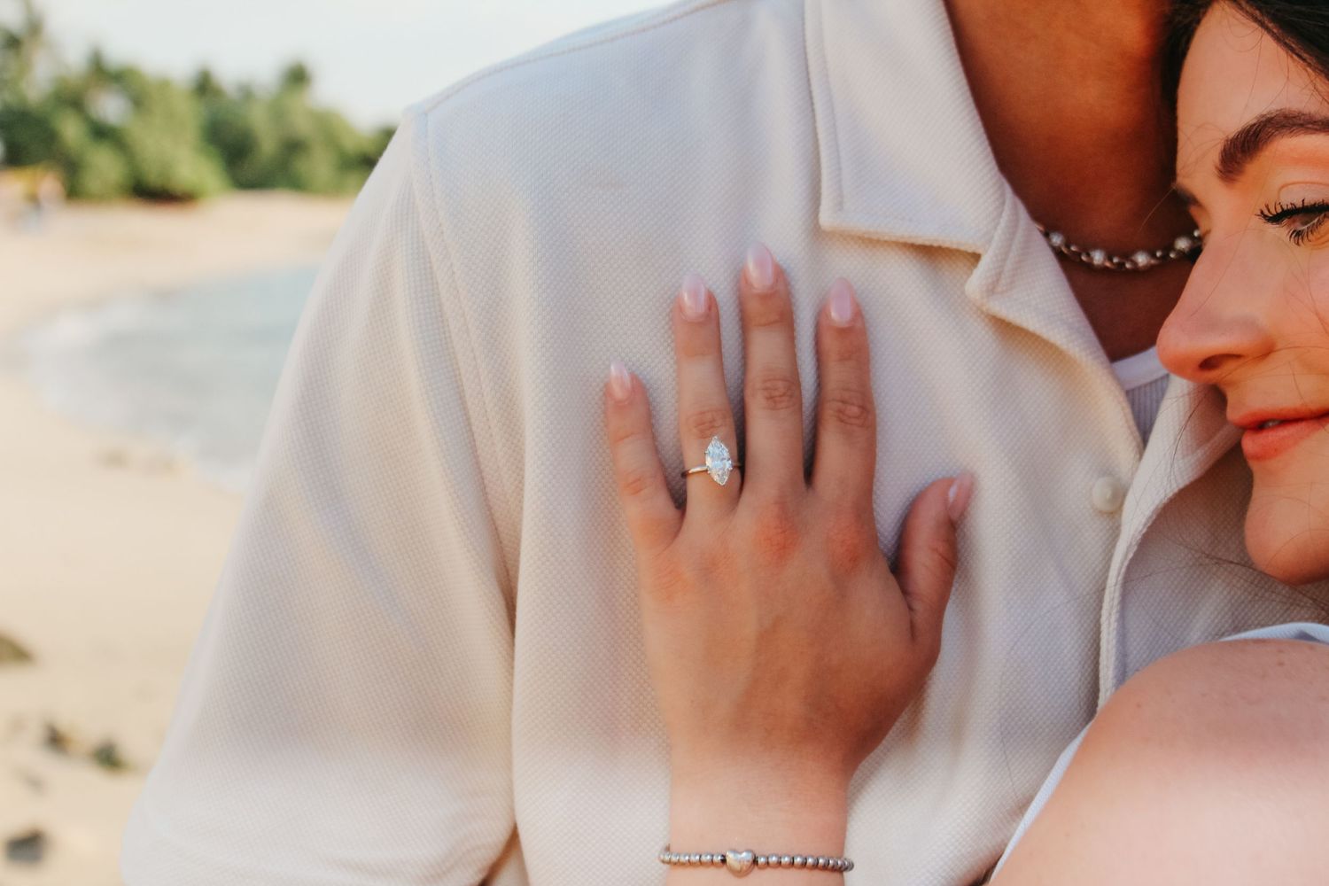 Couple walking on beach after proposal Kona Hawaii sunset