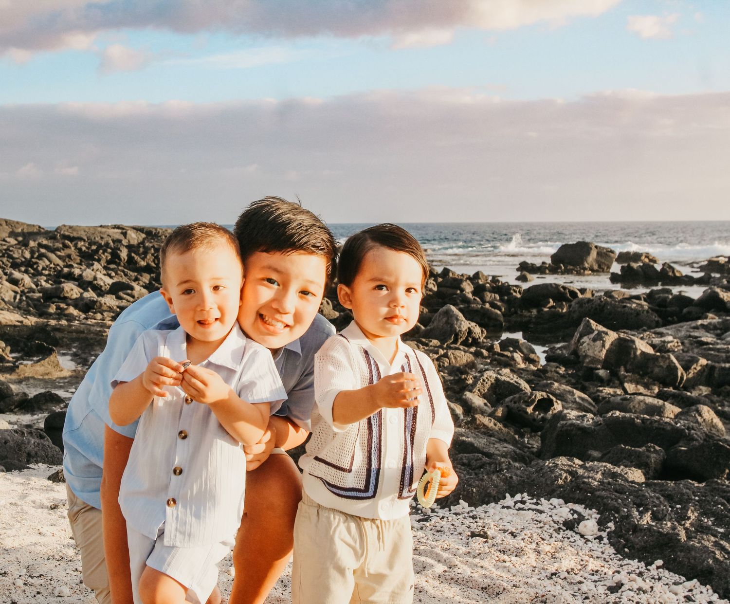 Sunset family session of three brothers on beach in Kona Hawaii