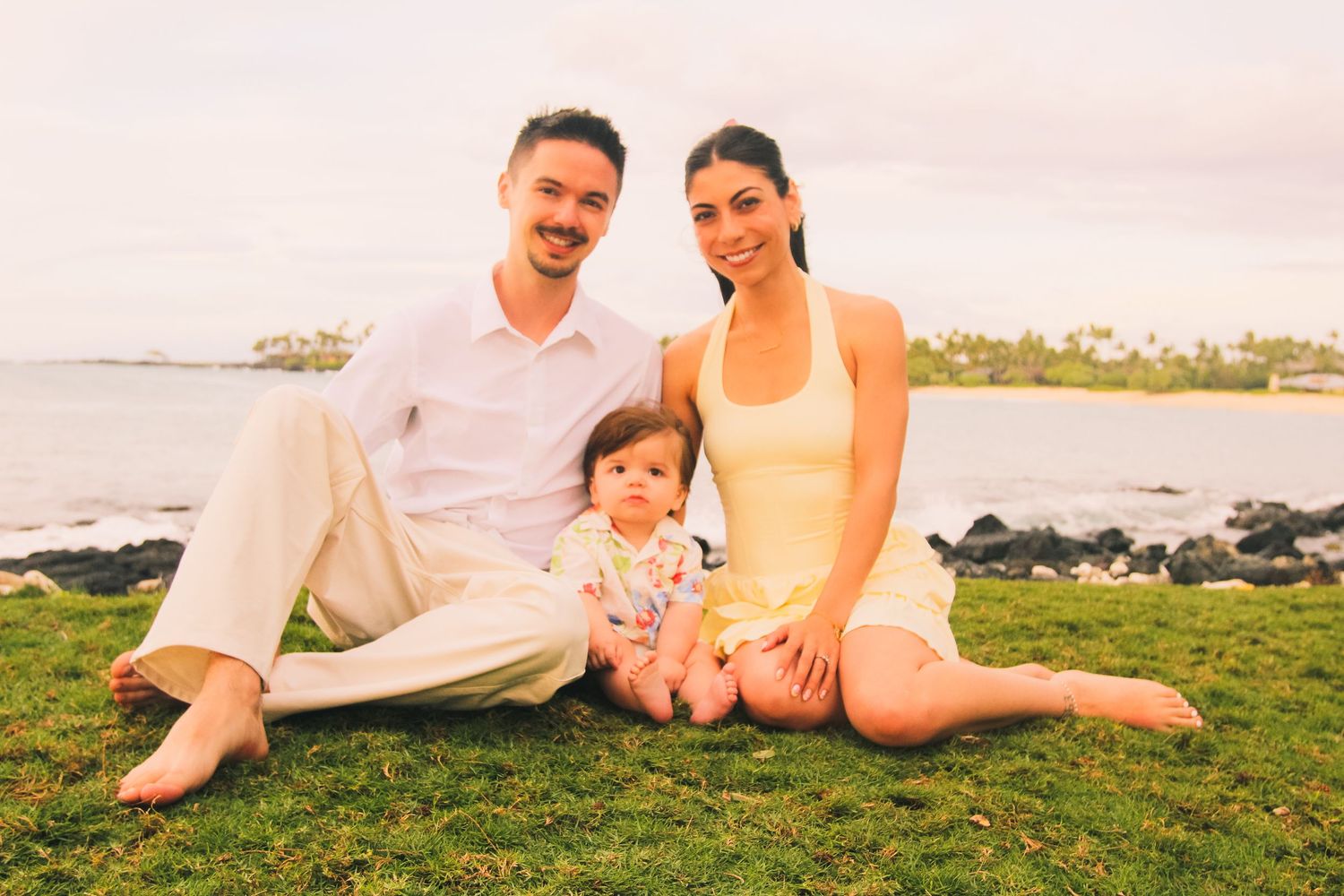 Kaikaua Point Beach Park sunset family session parents with toddler on grass Big Island Hawaii photographer