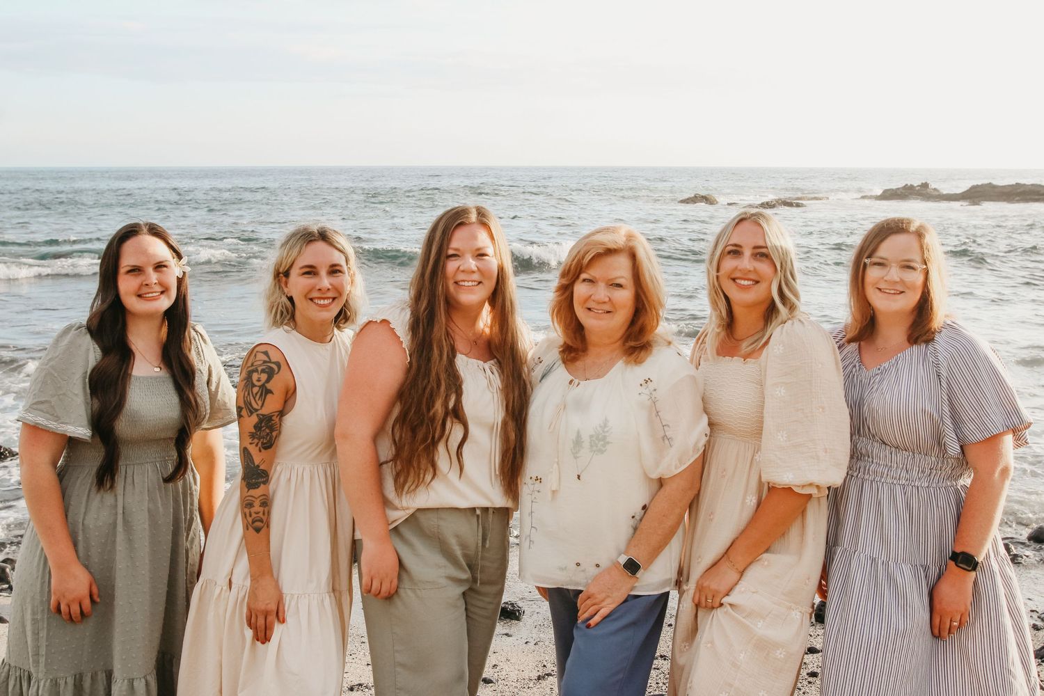 Small group of six women from large family of 18 during sunset beach session in Kona Hawaii