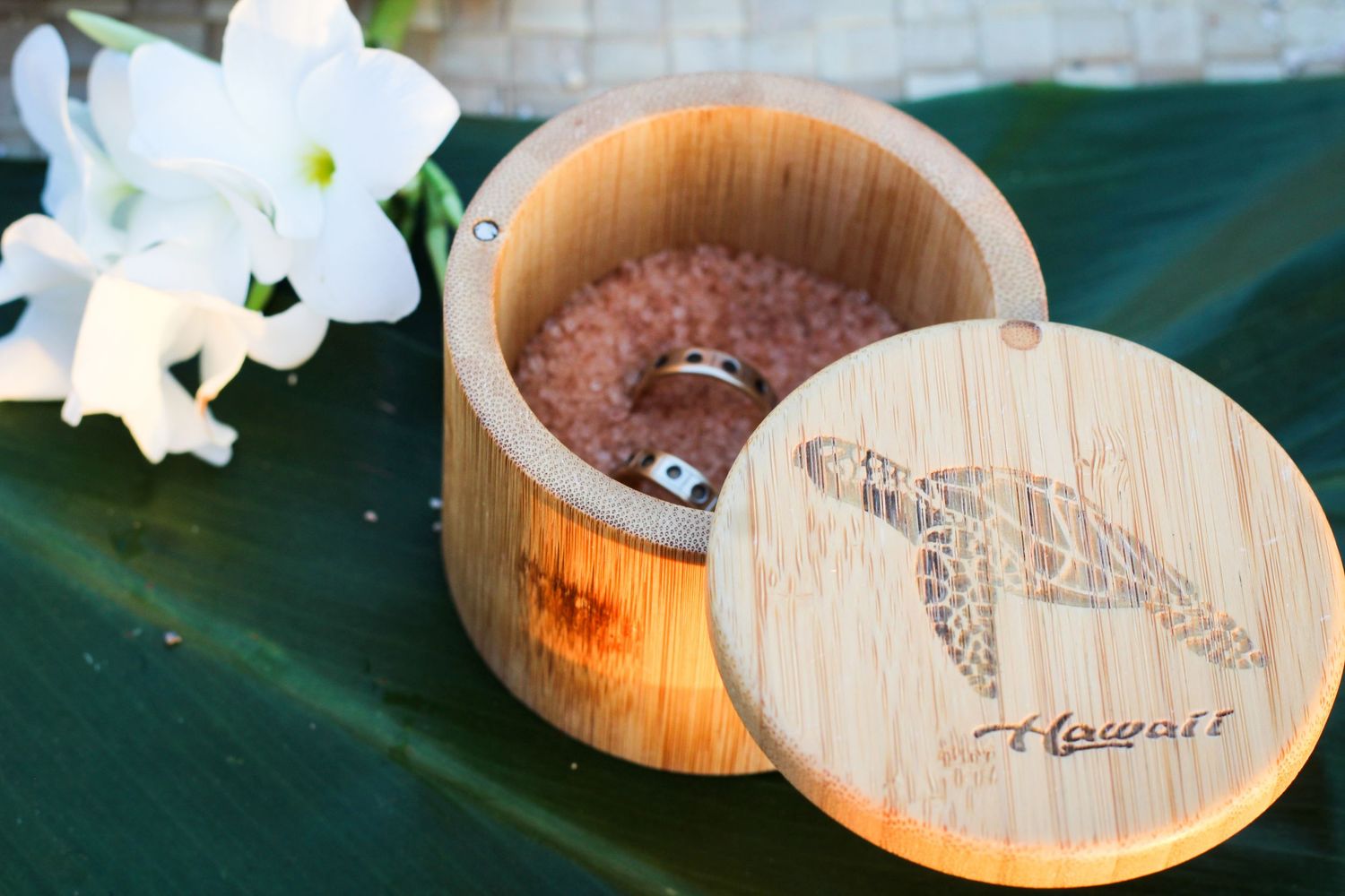 Close-up of ceremony salt blessing and wedding rings at Old Airport Beach Kona Hawaii
