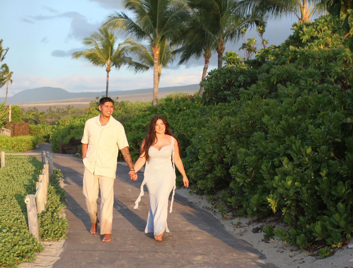 Couple sitting by picnic setup after proposal Big Island Hawaii