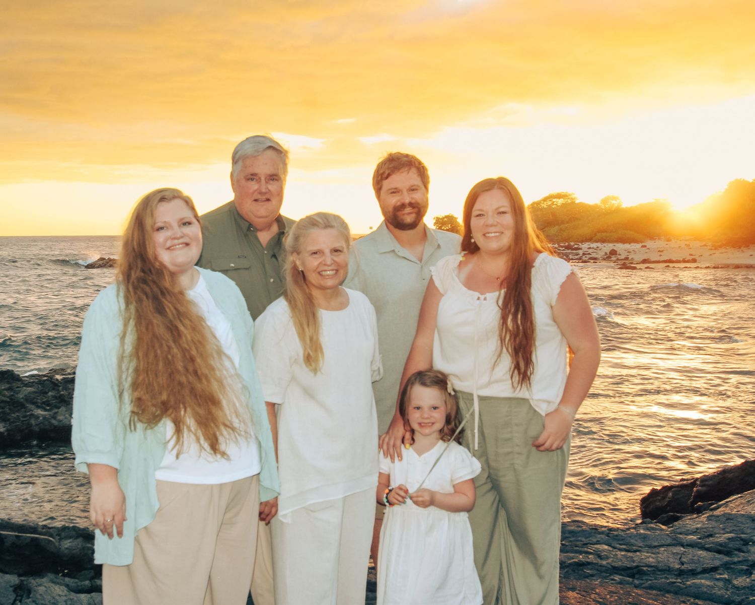 Small group of six from large family of 18 during sunset beach session in Kona Hawaii