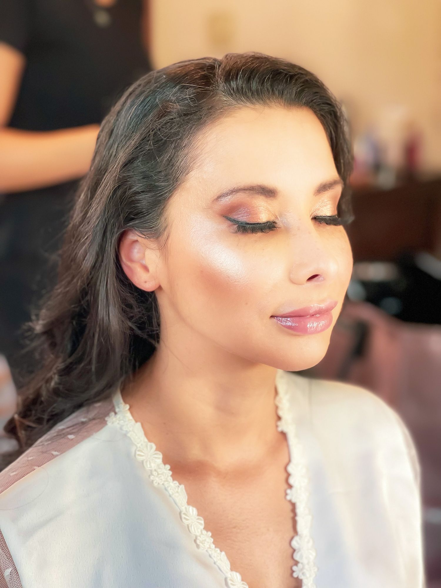 Bride with completed makeup getting ready in soft natural light for wedding in Hawaii