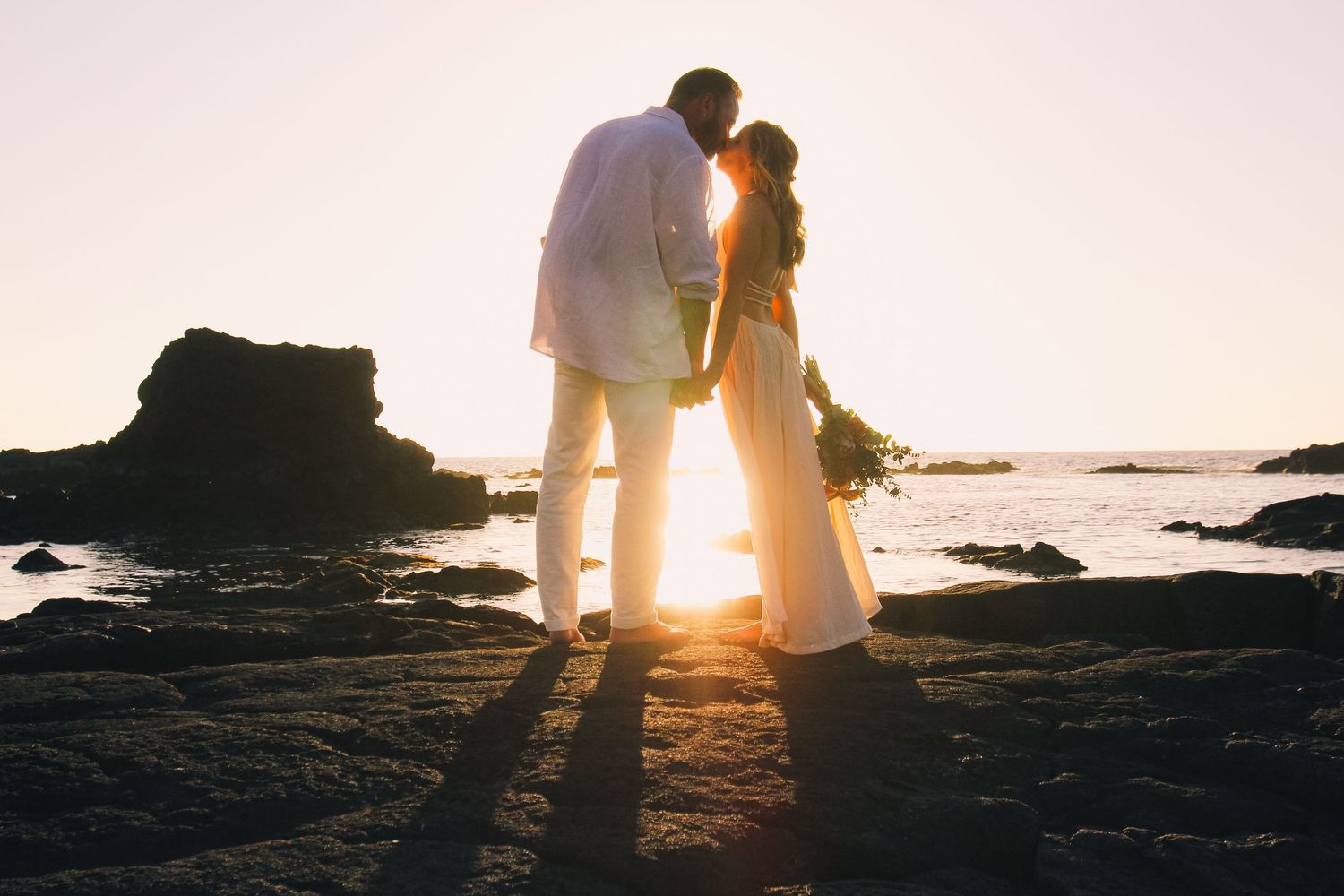 Kukio Beach sunset wedding couple on lava rocks Big Island Hawaii photographer