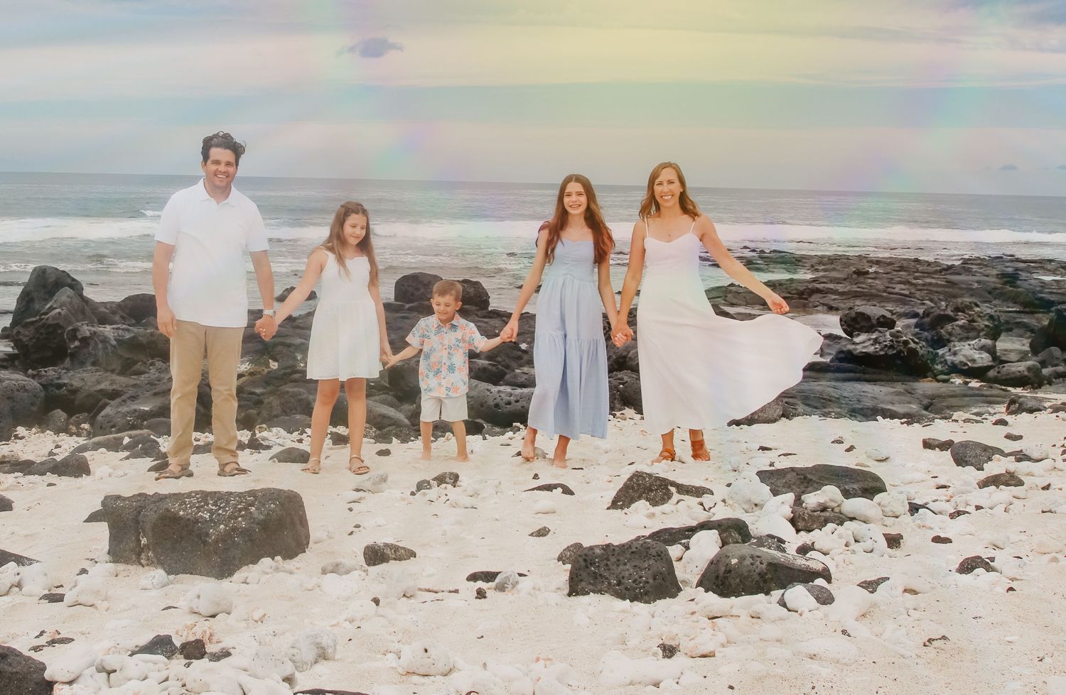 Family photos on black lava rocks beach Big Island Hawaii golden hour session