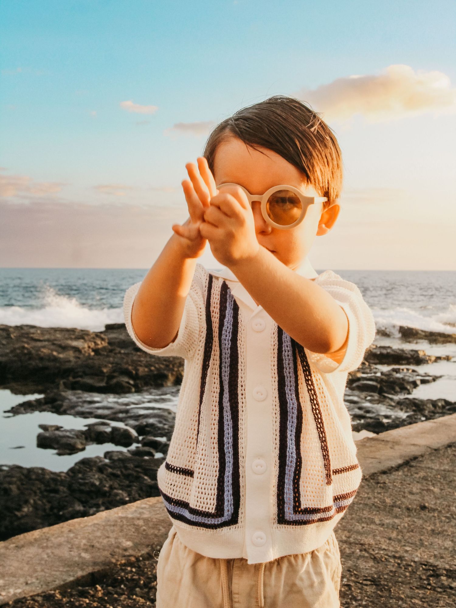 Candid toddler playing in the sand on beach in Kona Hawaii