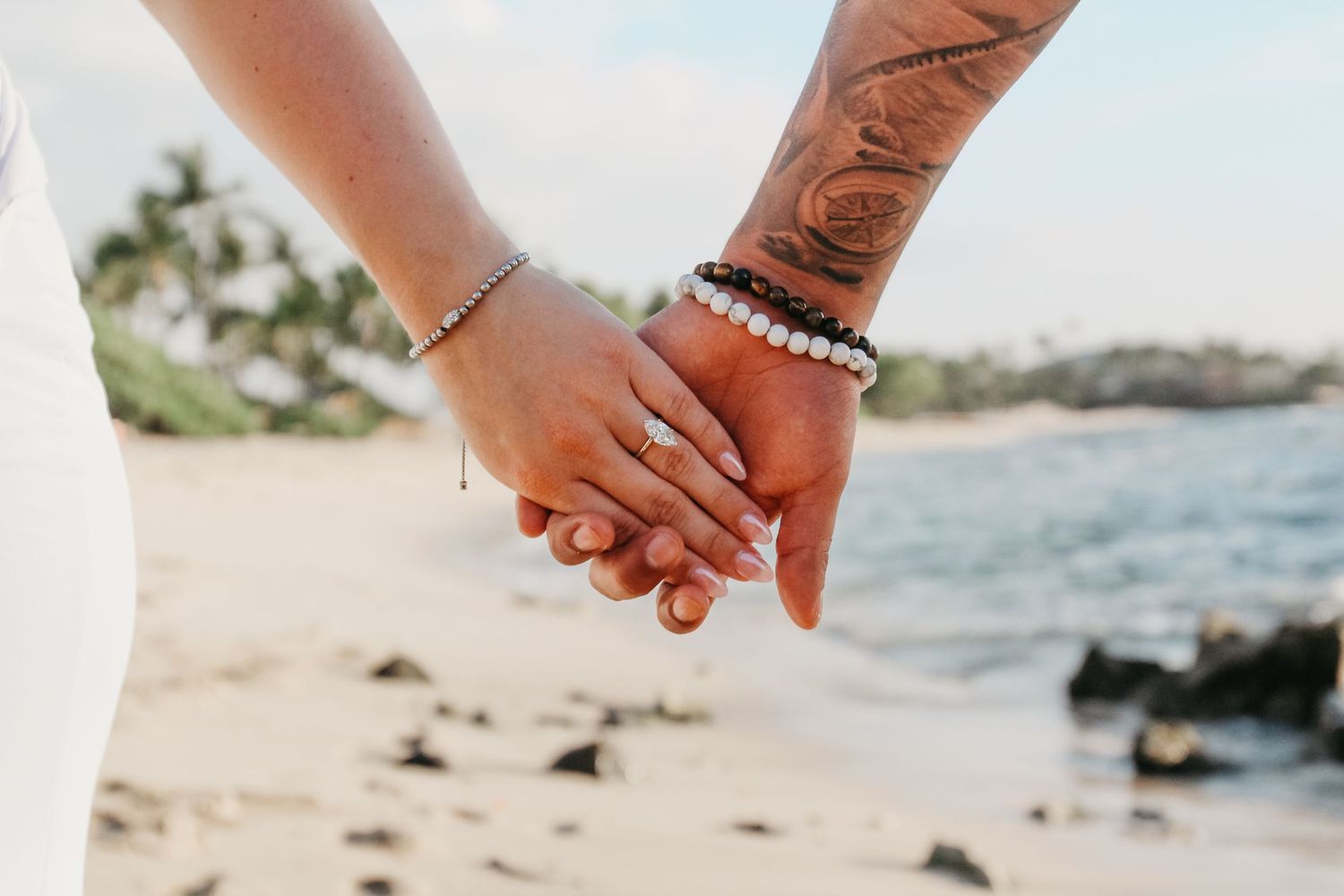Candid engagement moment on Big Island Hawaii beach at sunset