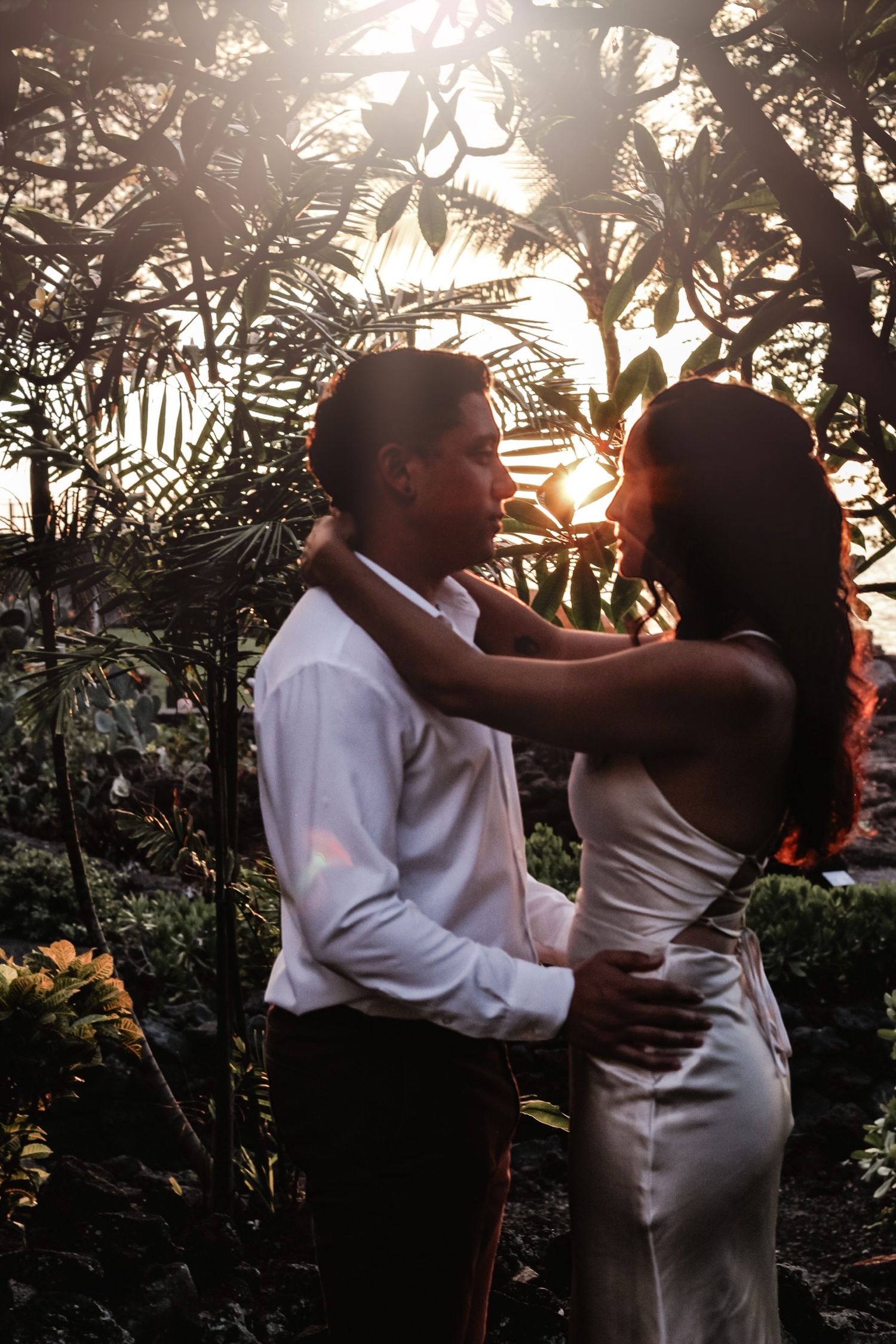 Moody sunset elopement couple looking at each other in garden at Outrigger Kona Resort Hawaii