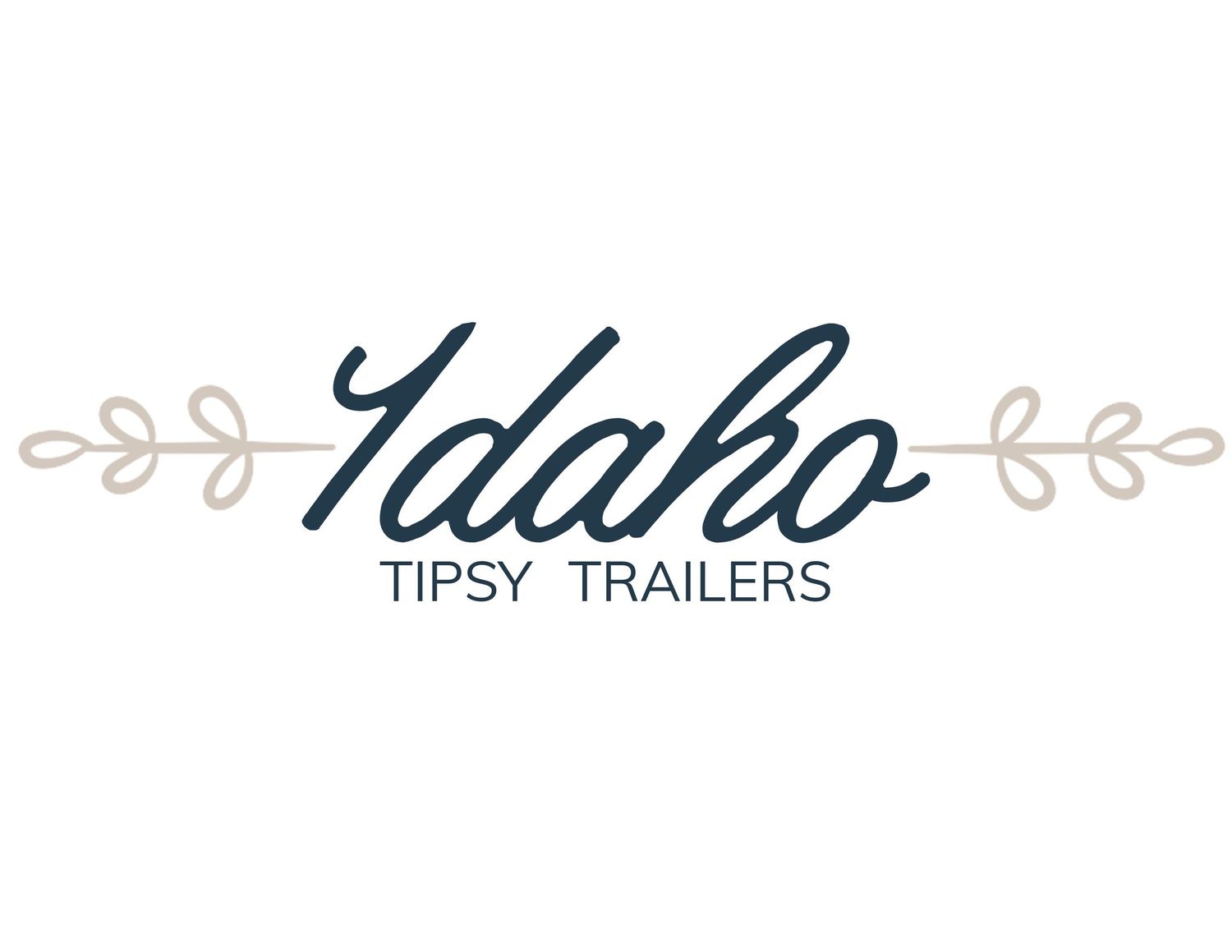Idaho Tipsy Trailers logo in navy script lettering with decorative leaf branch accents.