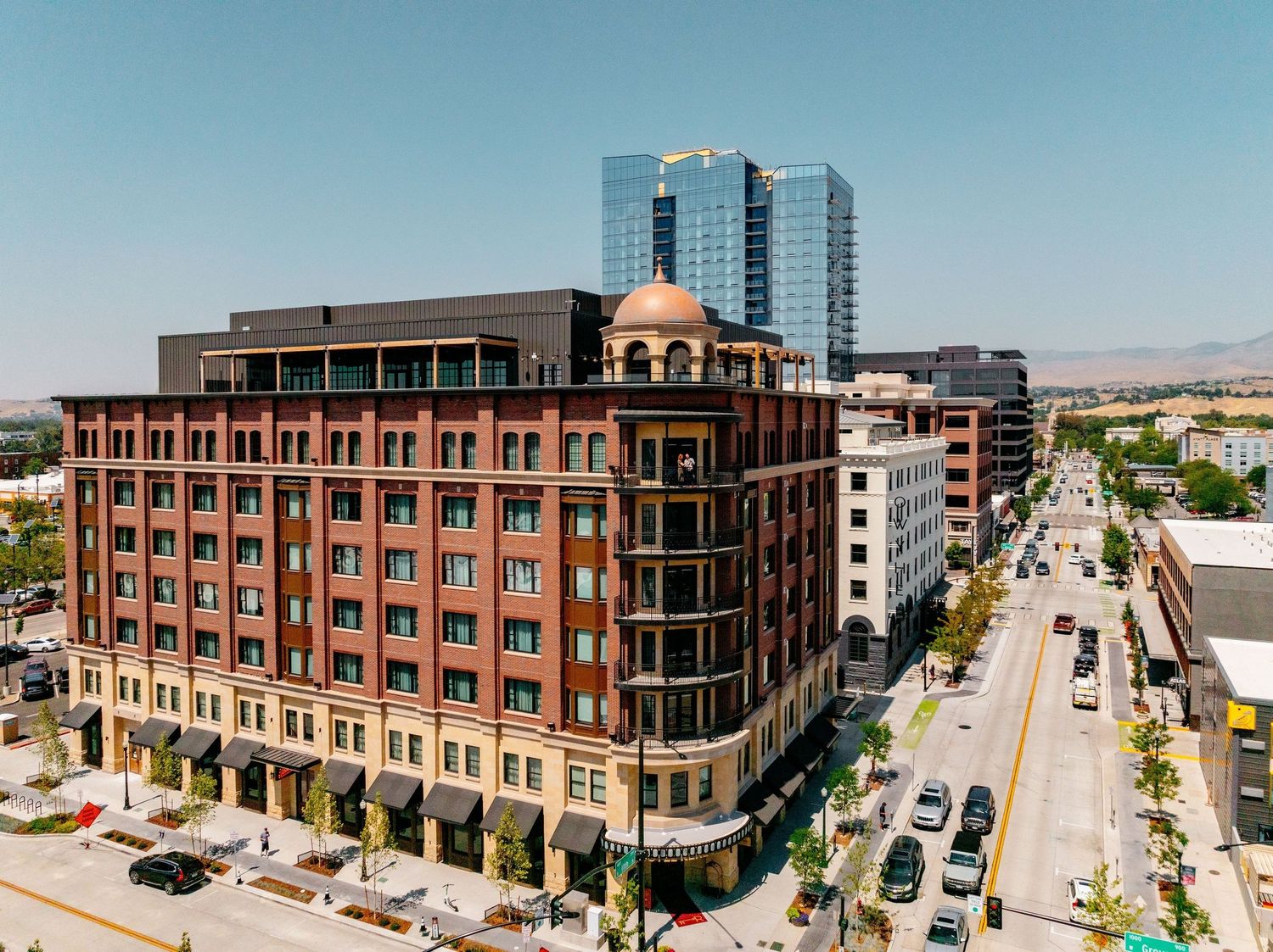 Aerial view of historic brick Hotel Renegade building in downtown Boise Idaho cityscape.
