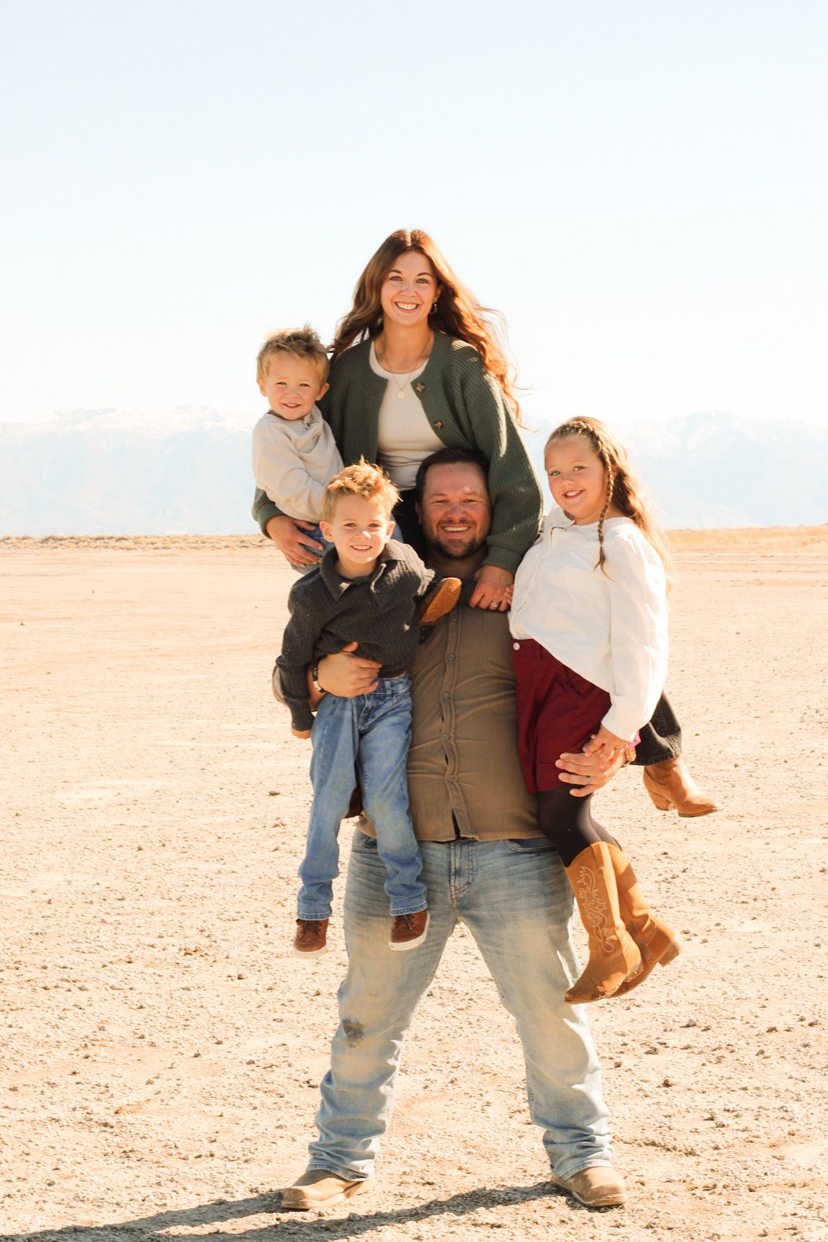 Jaron hold his entire family on the beach at Antelope Island, UT.