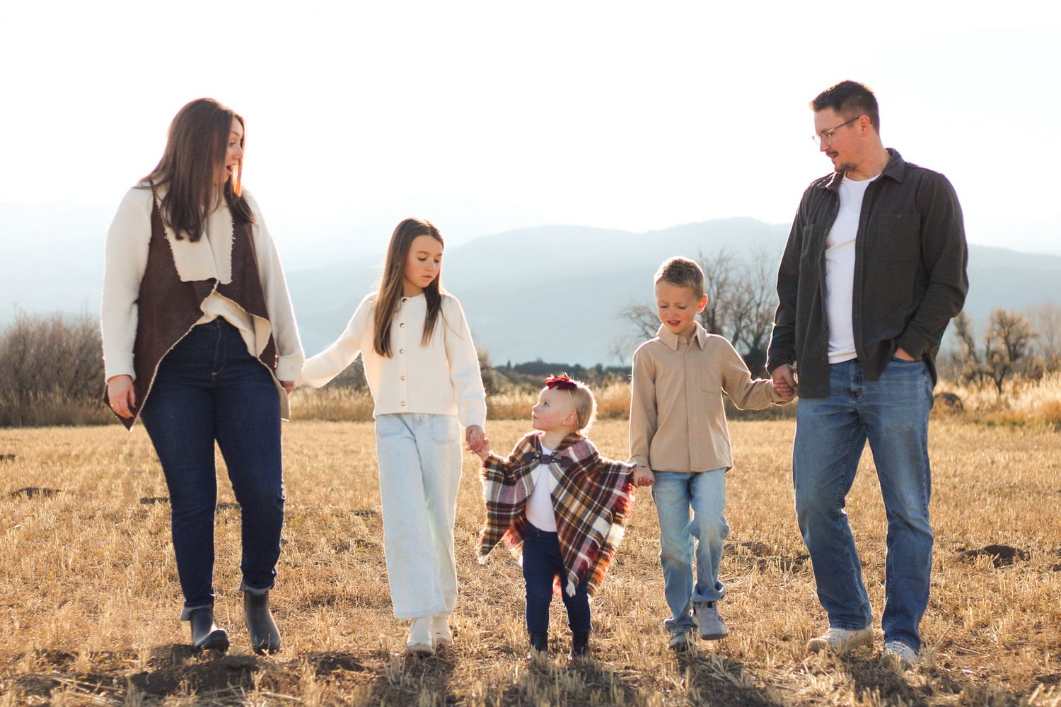 The Reiss family strolling through a field near their new house.