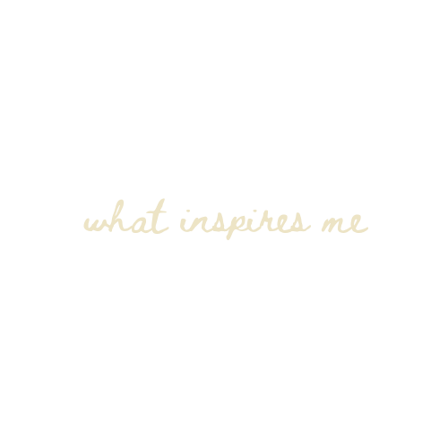Elegant cursive script reading 'what inspires me' in soft gold lettering on a white background.