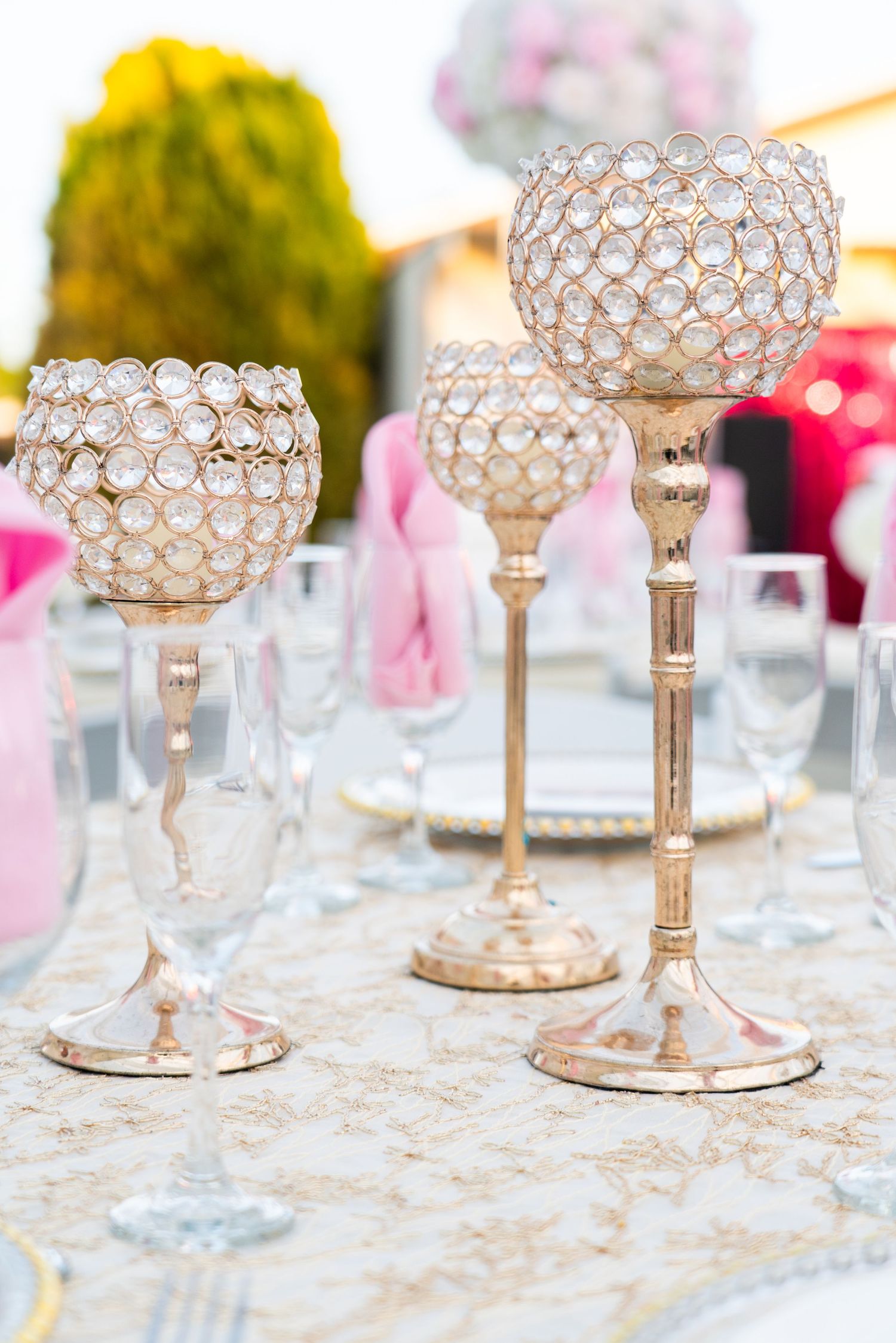 Crystal beaded candle holders arranged on an elegant table setting with lace details.