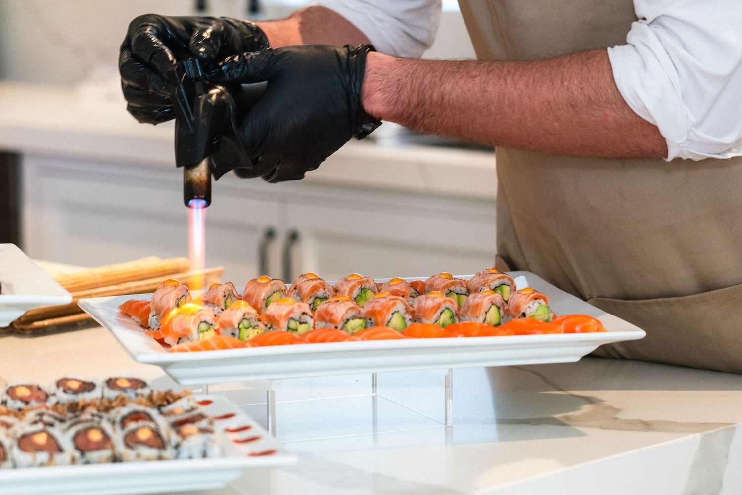 Close-up of catering preparation with various appetizers being plated.