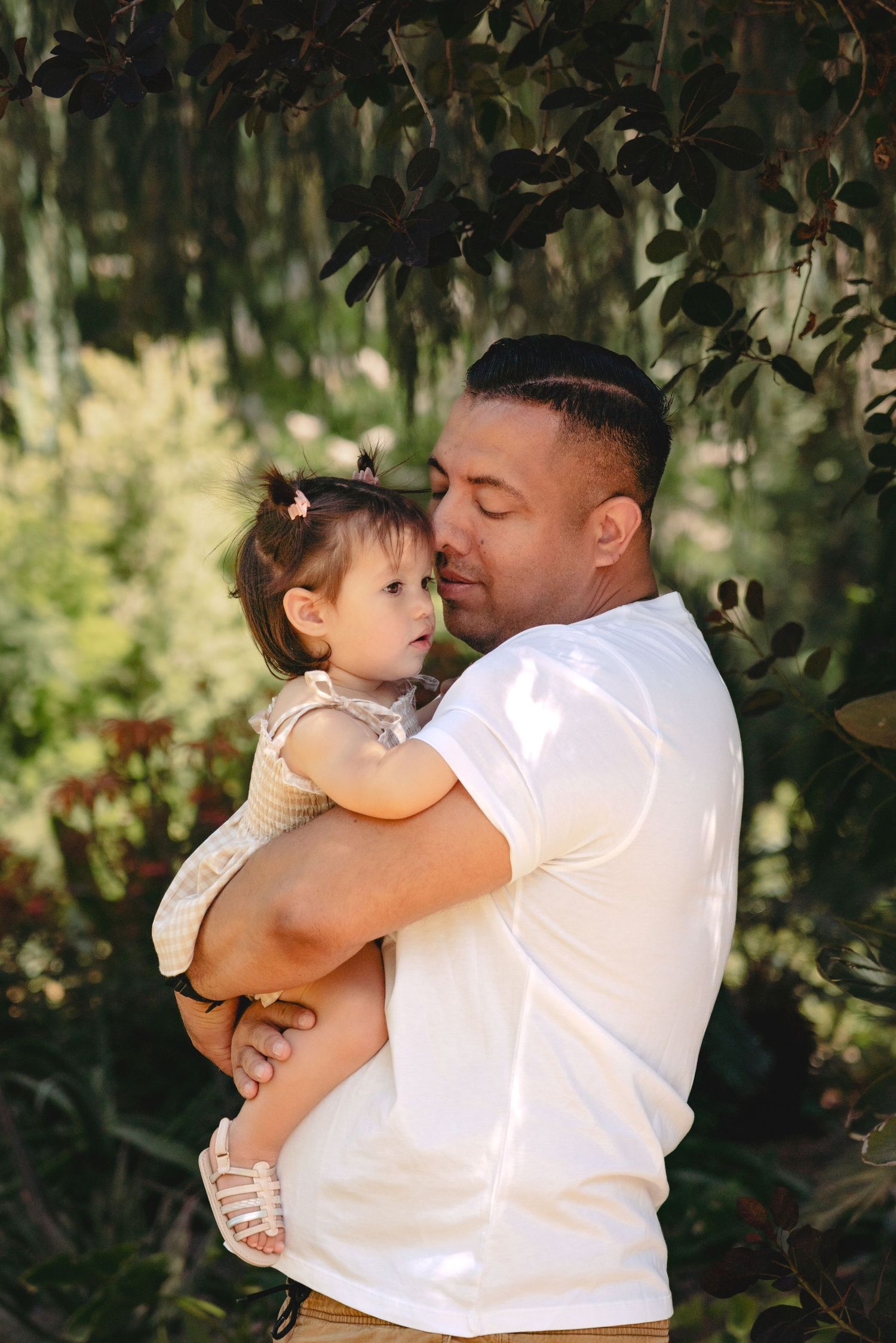 Candid moments of family bonding in a natural outdoor setting.