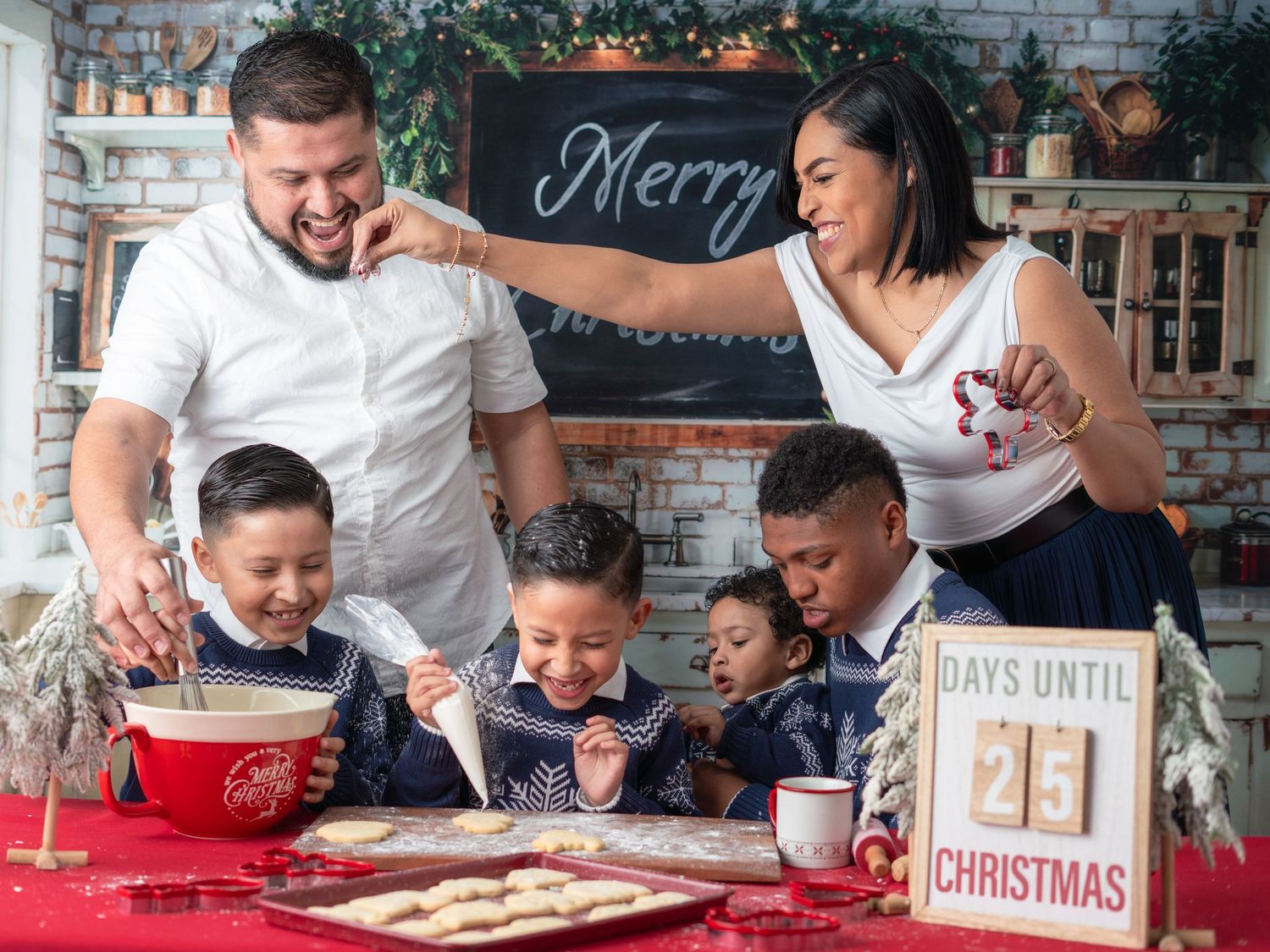 A family gathers in a festive kitchen to bake and decorate Christmas cookies together during the holiday season.