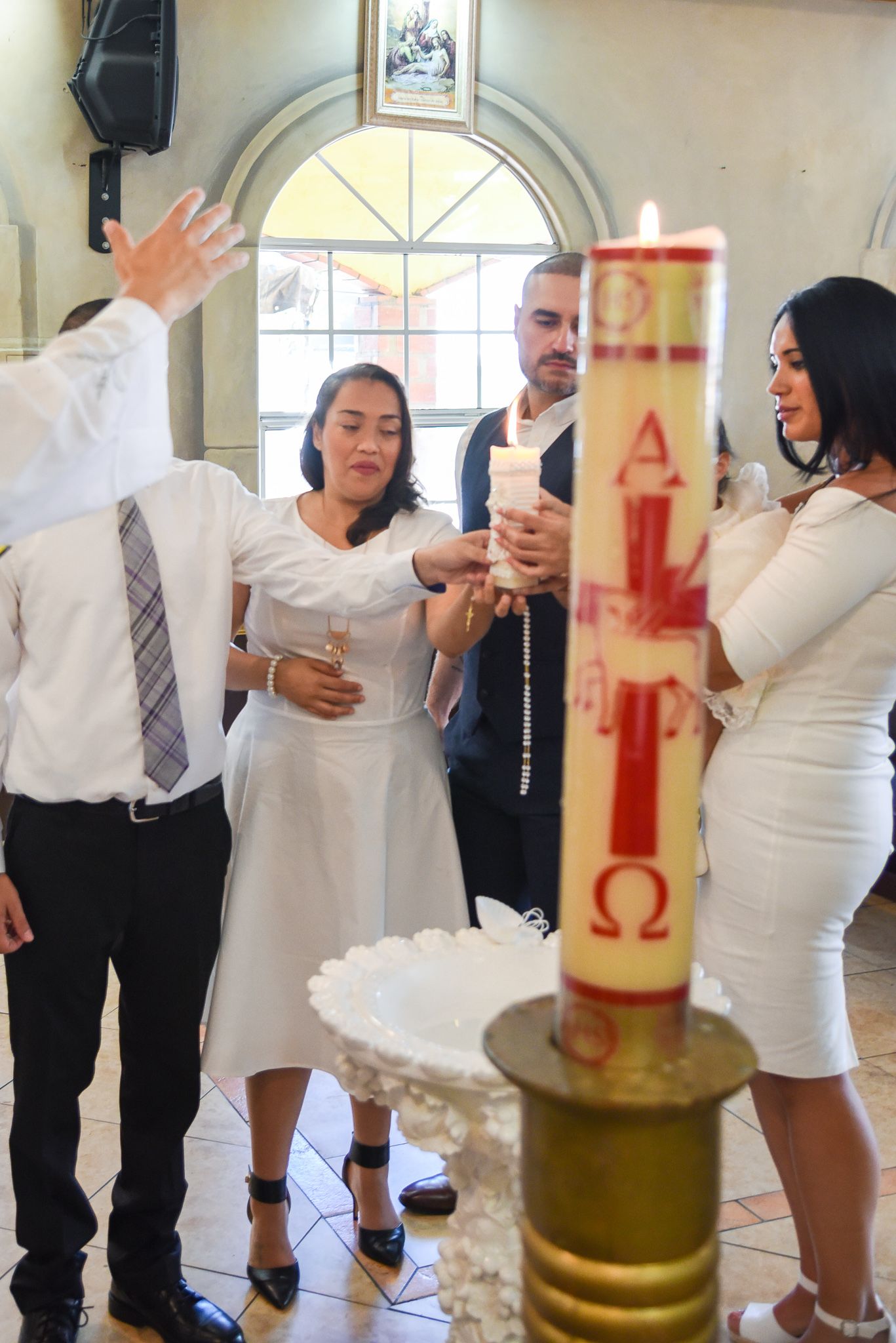 Event guests in formal attire socializing at a celebration with drinks.