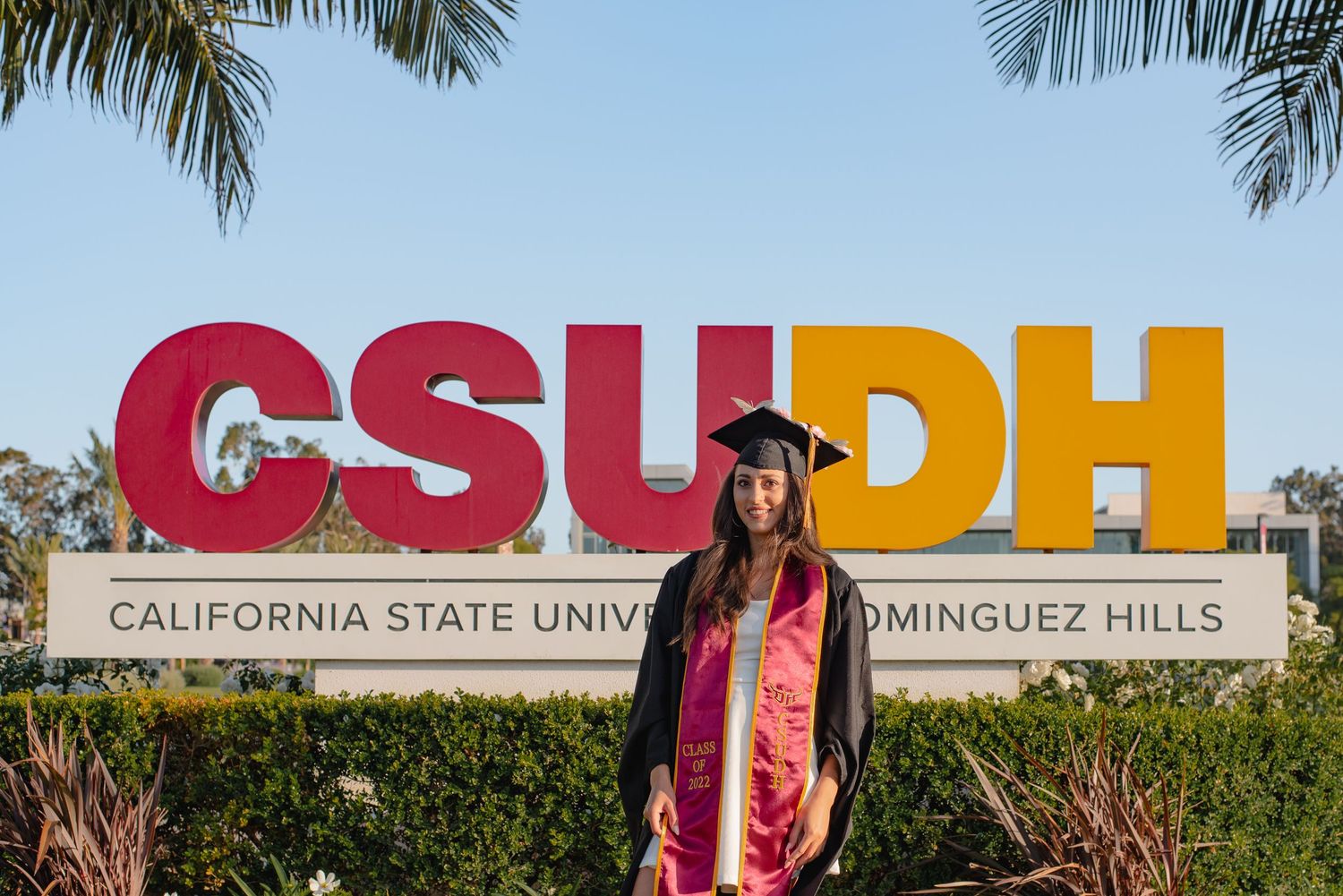 CSUDH university sign with palm trees visible in background.