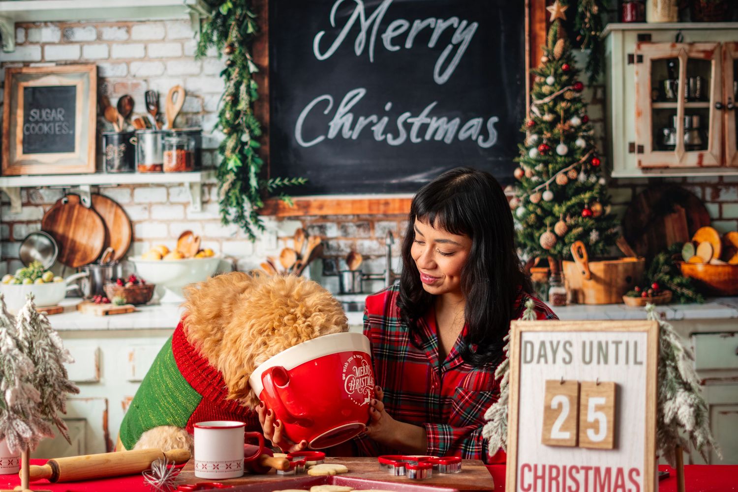 Festive kitchen decorated for Christmas with brick wall, chalkboard signs and holiday greenery.