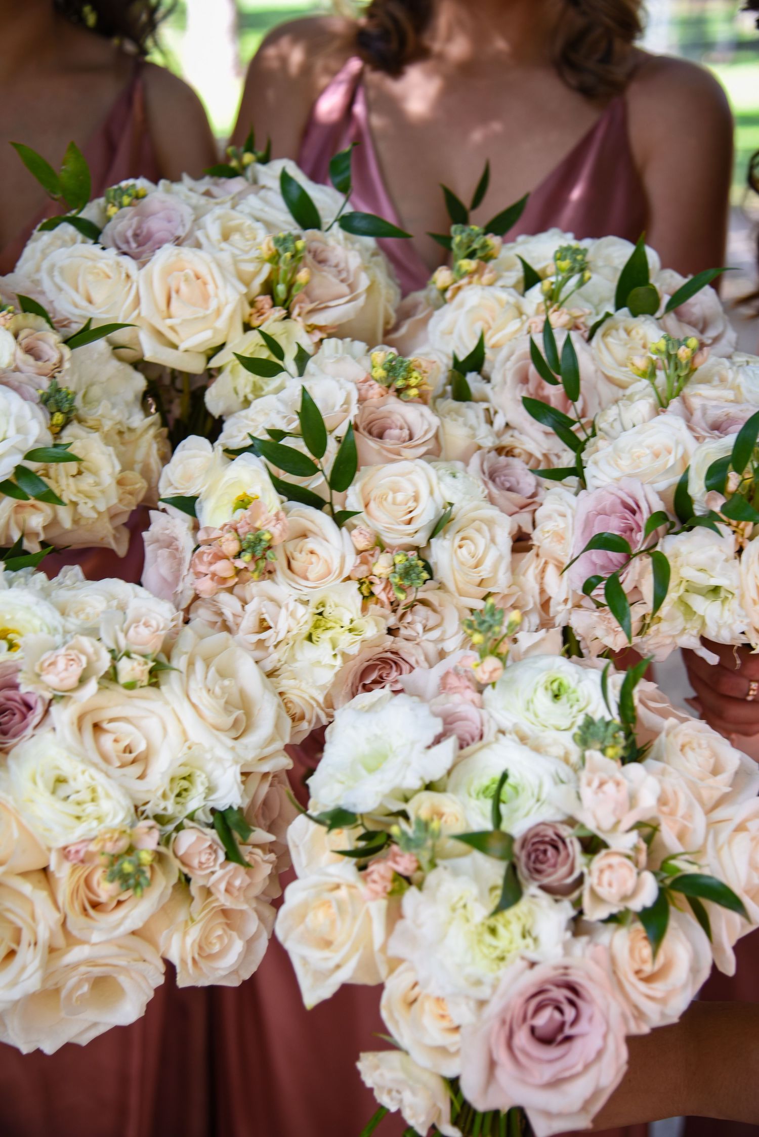 A beautiful arrangement of cream and blush roses with delicate greenery.