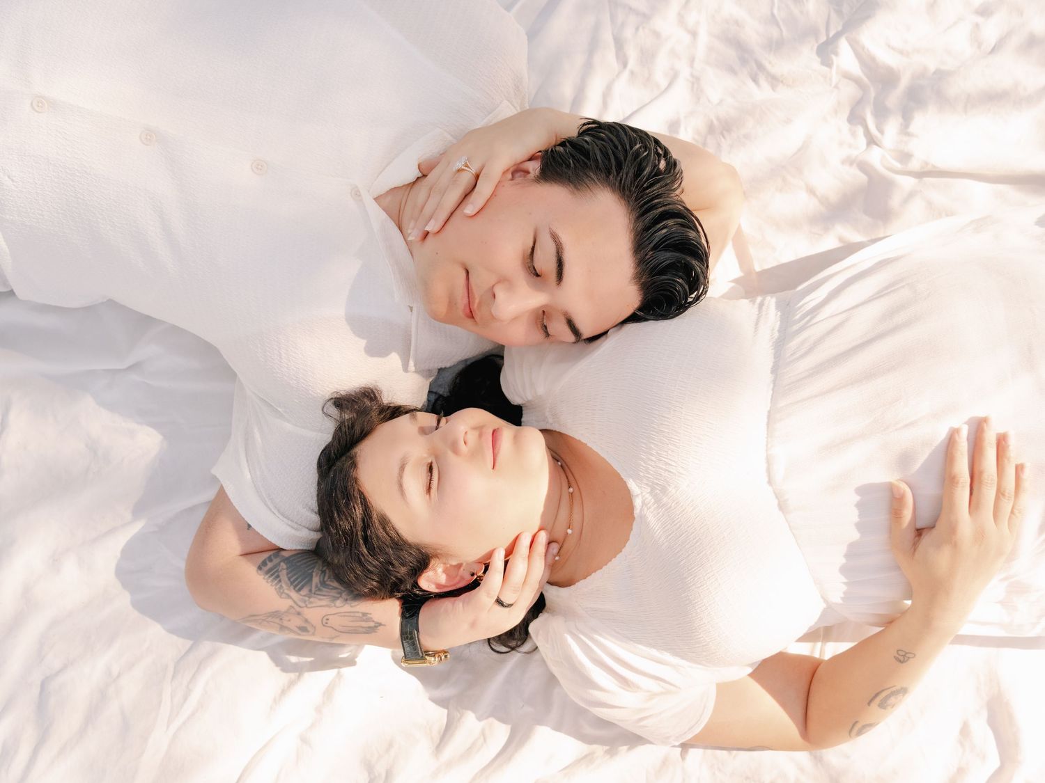 Dreamy white studio portraits showing intimate poses against light background.