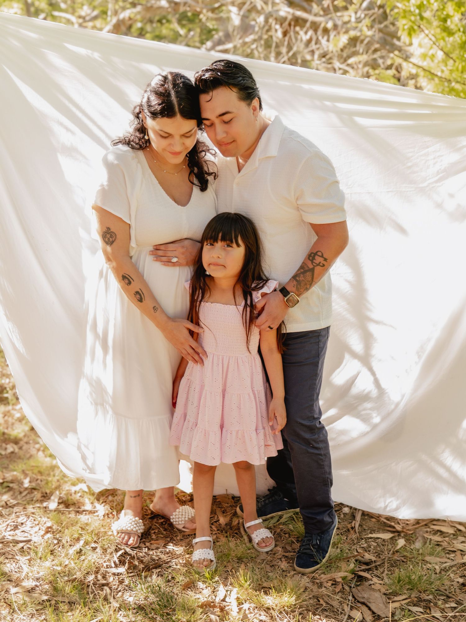 Outdoor family photos against white backdrop showing tender moments together.