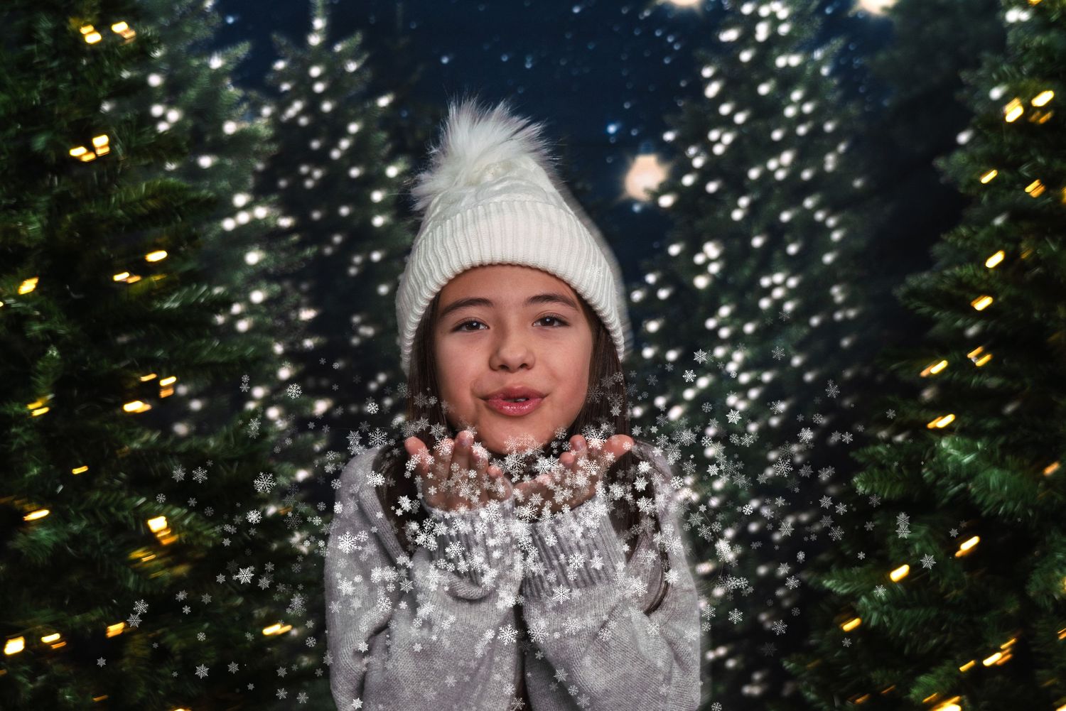 A series of winter portraits showing someone playfully enjoying falling snow against a backdrop of illuminated evergreens.