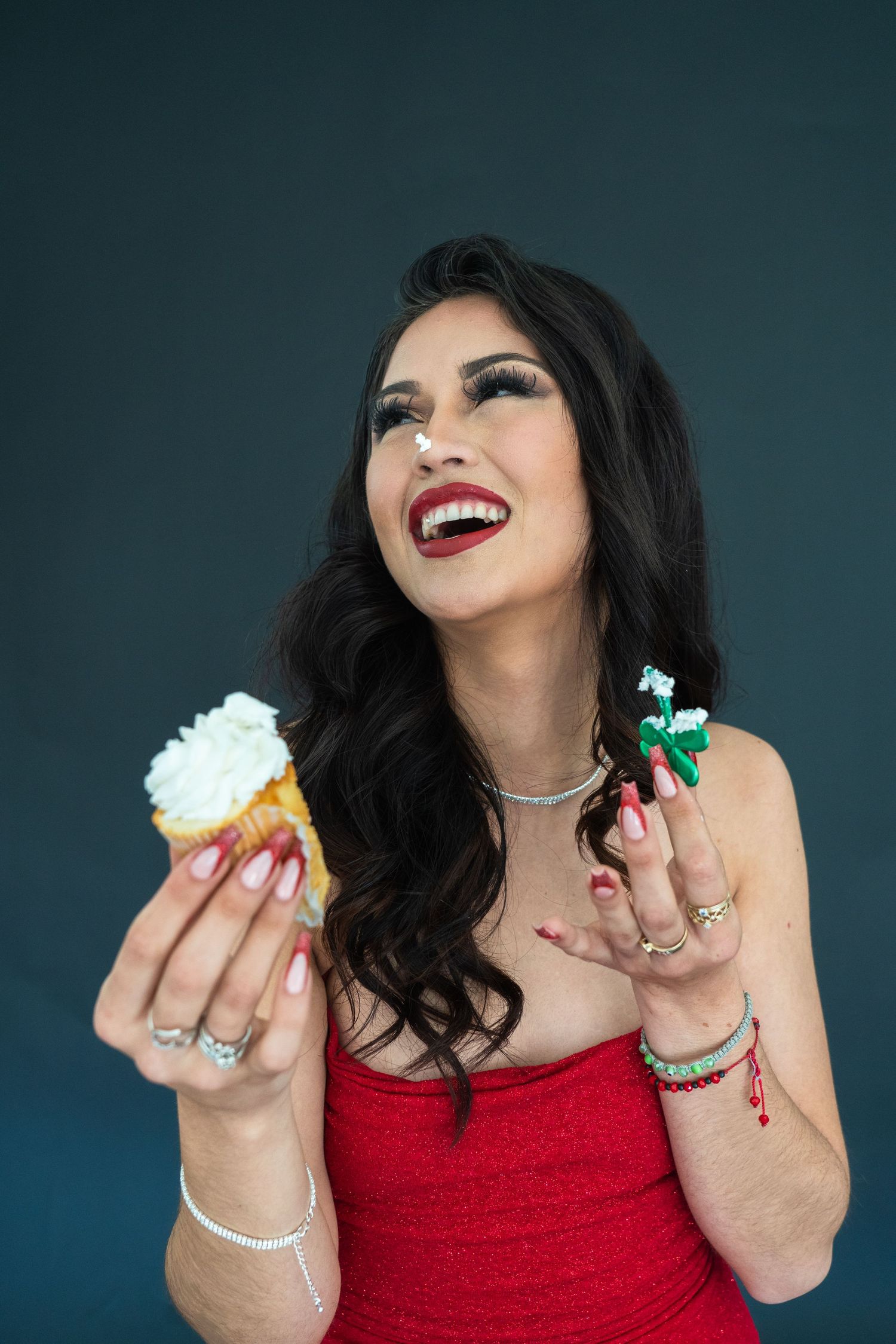 A joyful moment with a cupcake and sparkly decorations against a dark green background.