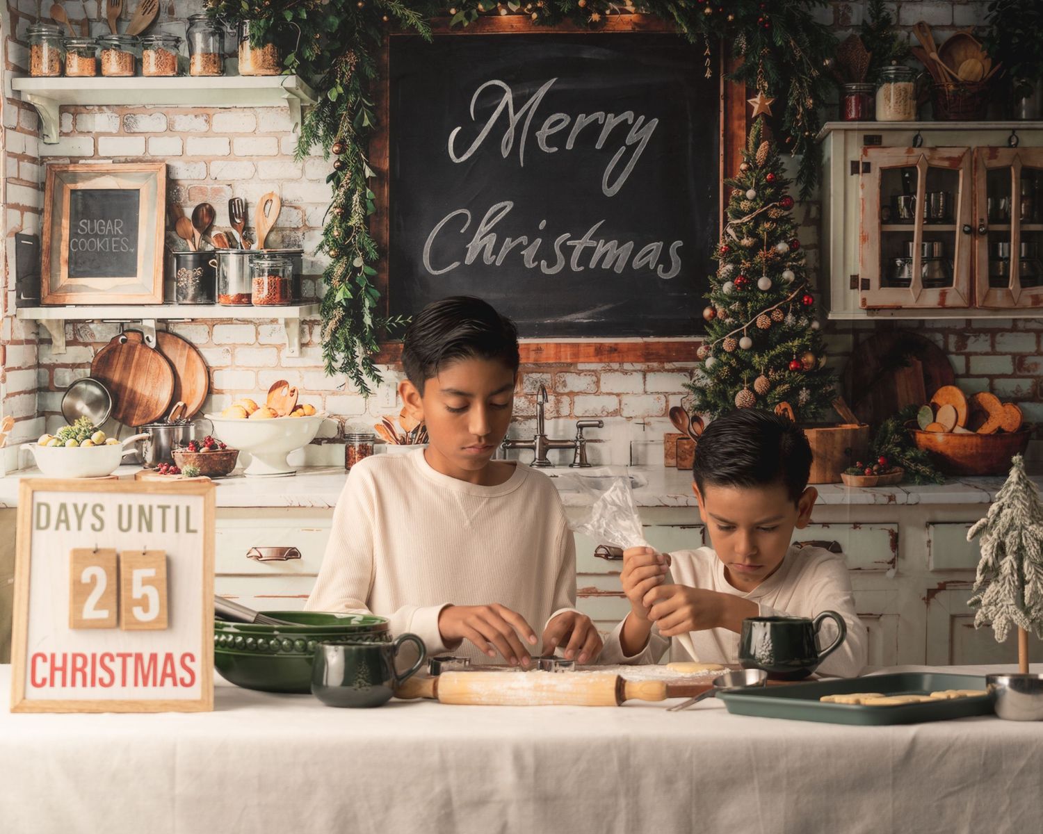 Two children work on Christmas crafts at a table with festive holiday decor and a Merry Christmas sign in the background.