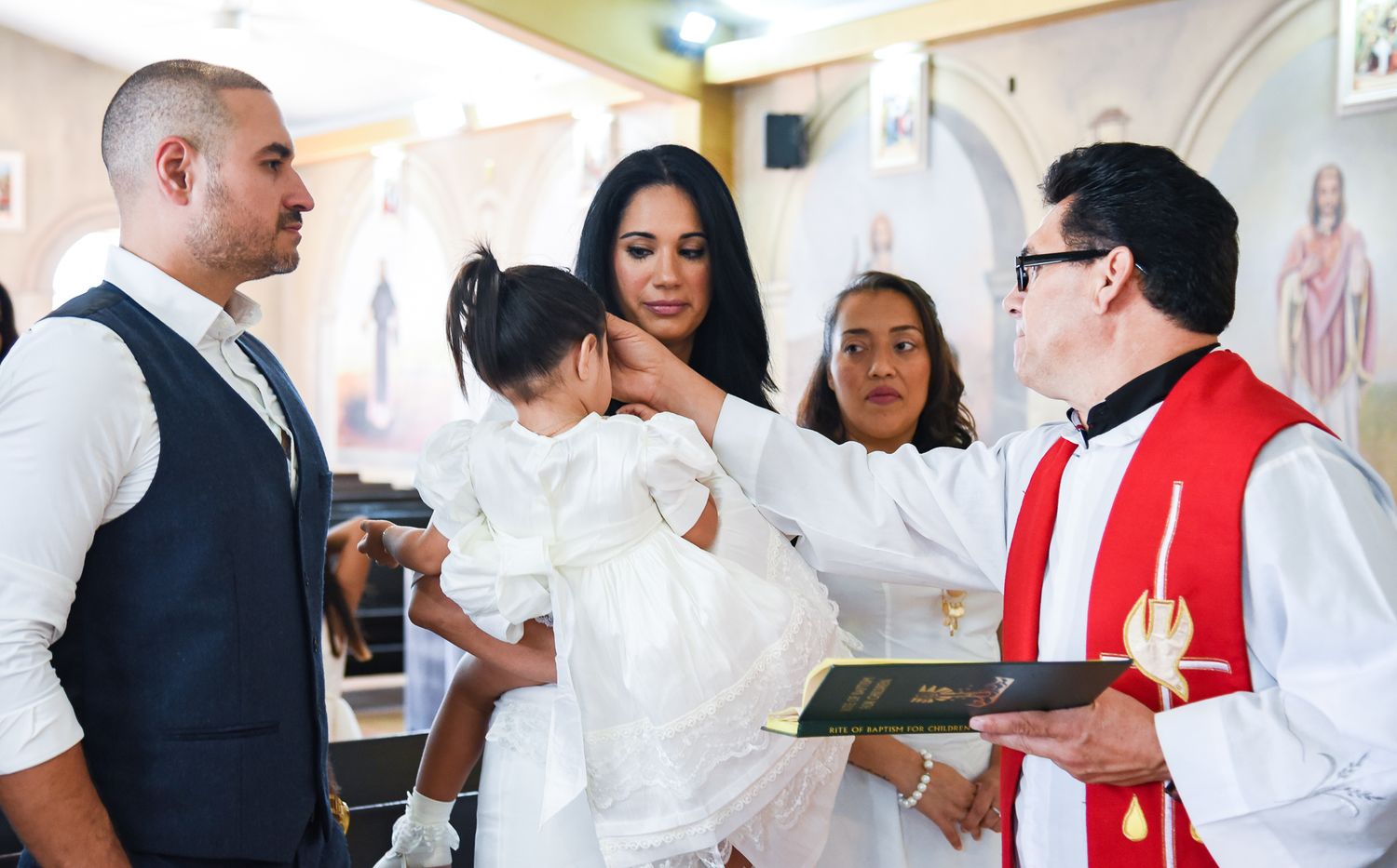 Professional catering staff in white uniforms serving at an elegant event.