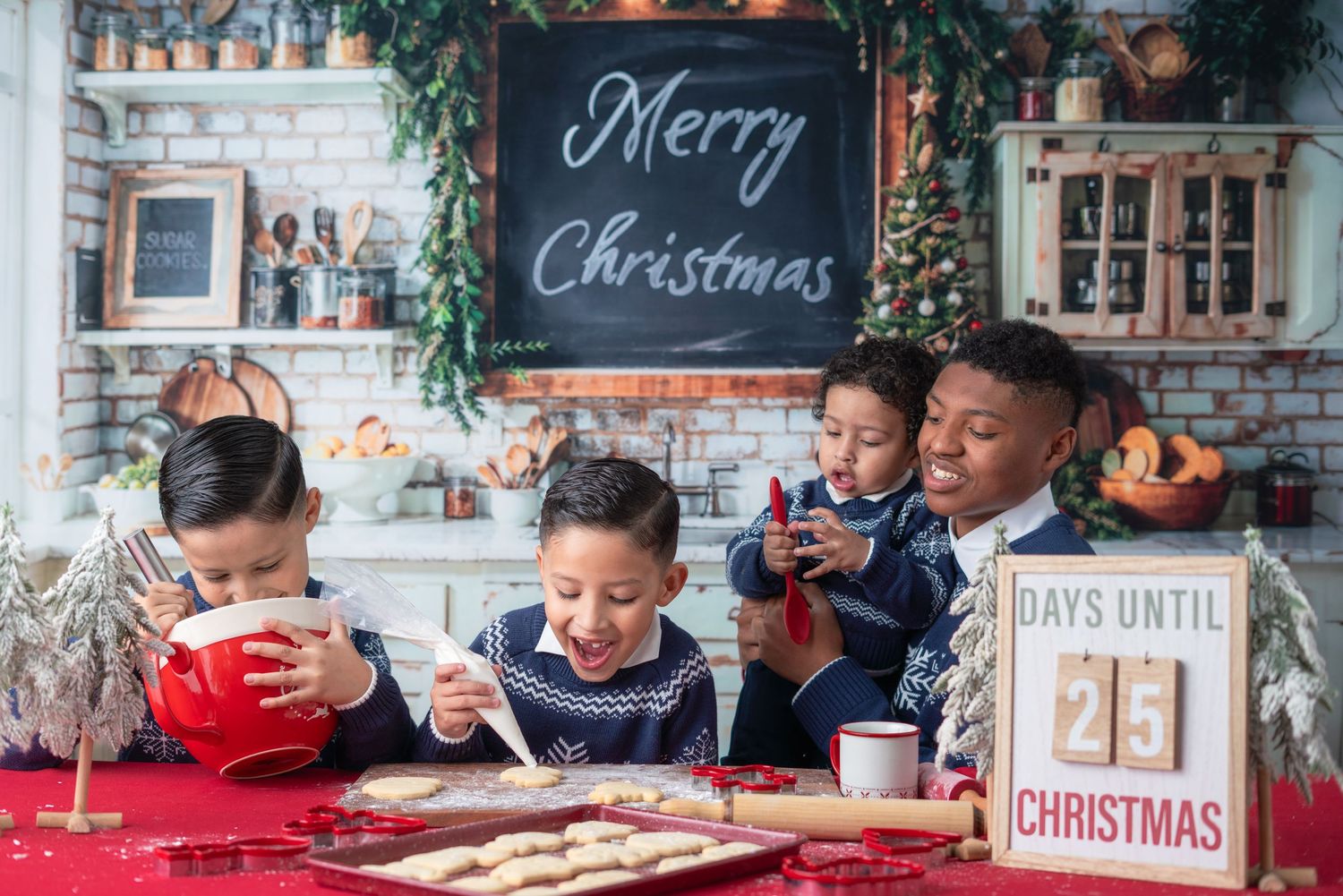 Children enjoying hot cocoa and cookies at a Christmas-themed table setting.