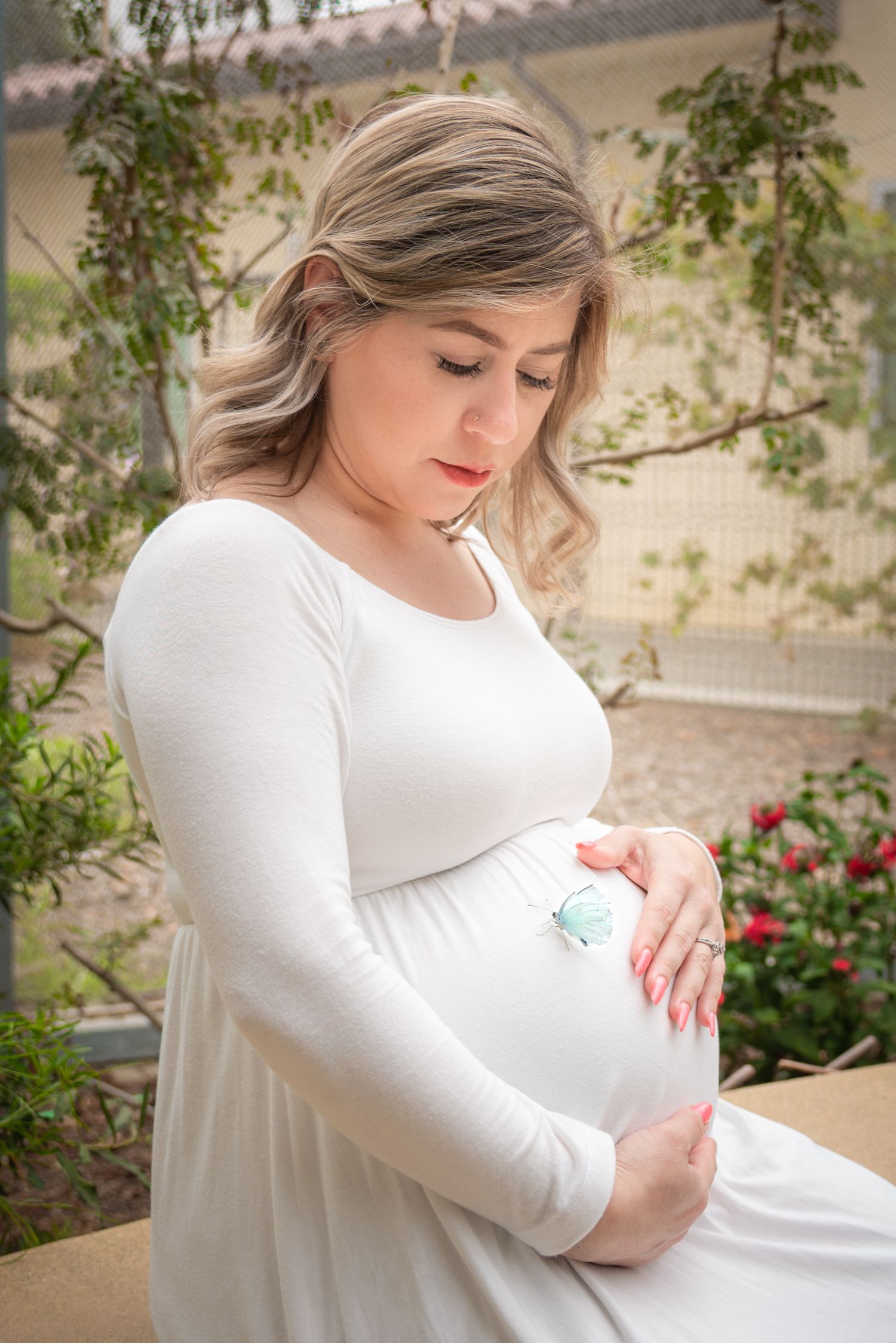 A series of maternity photos showing a pregnant woman in a white dress against a floral garden backdrop.