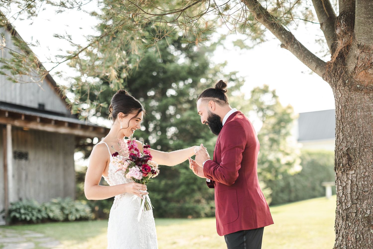 Couple in casual attire shares intimate moments during outdoor photo session at sunset in wooded setting.