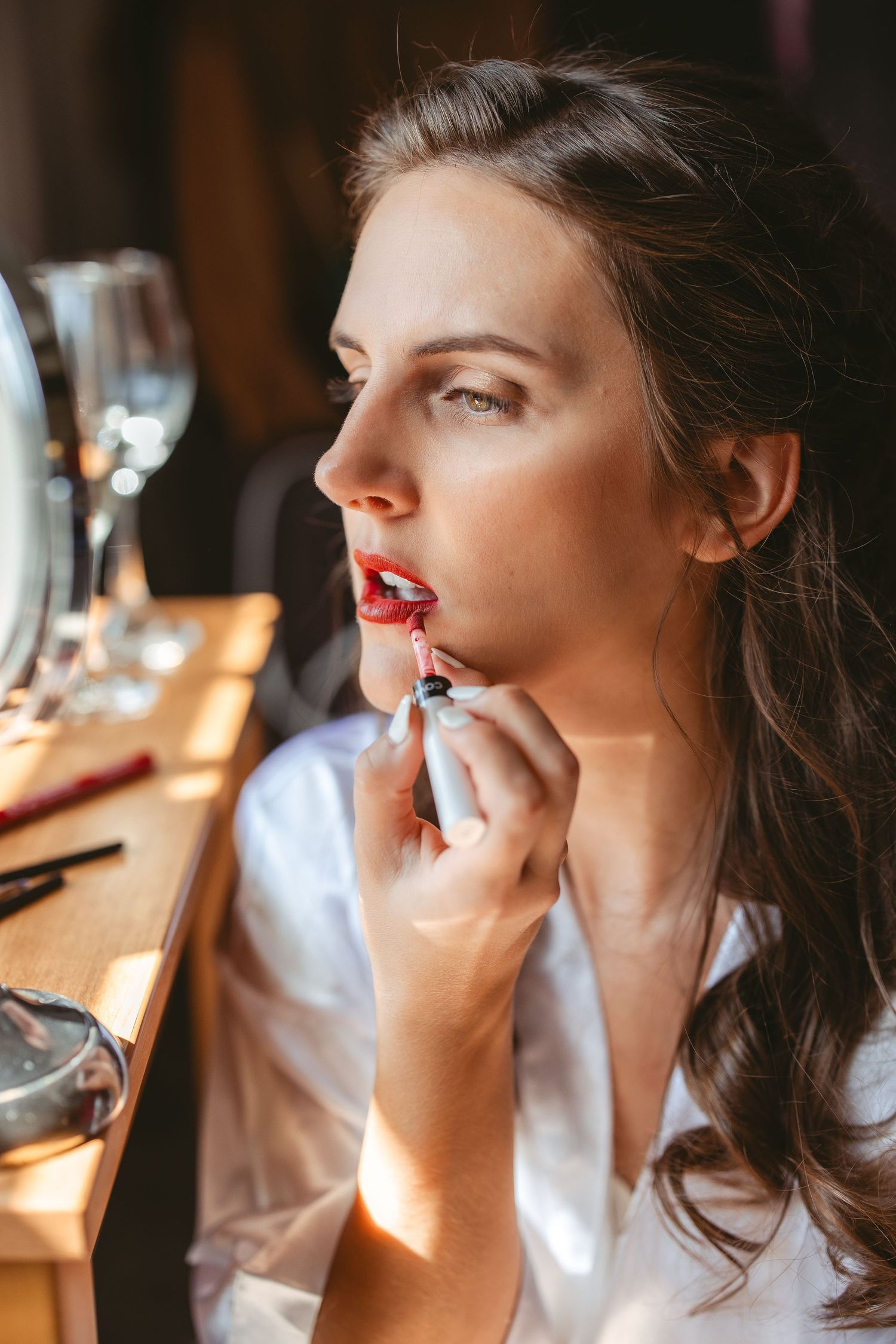 Close-up shots of makeup application focusing on red lipstick application.