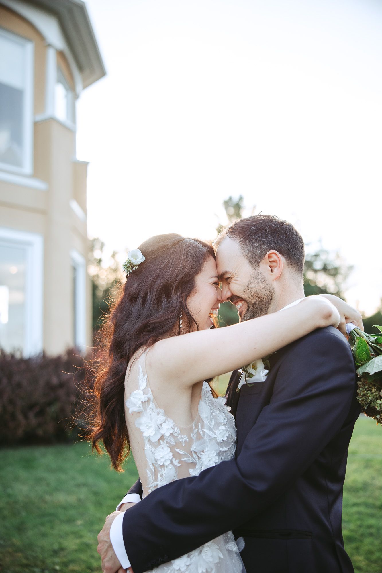 A romantic wedding couple shares intimate moments in a series of candid outdoor portraits at sunset.
