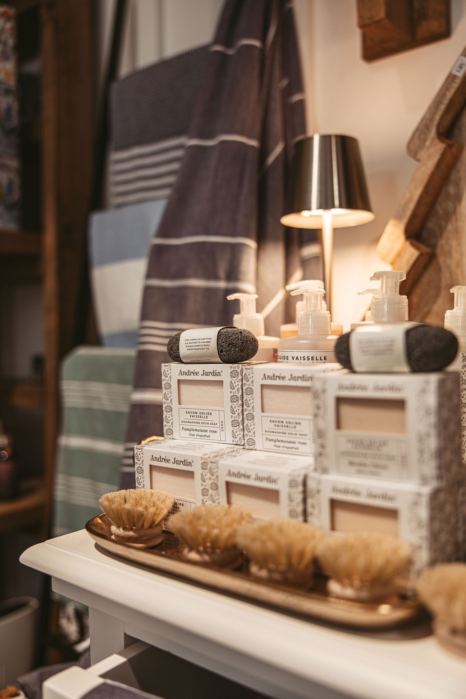 Retail shelf display featuring neutral colored products and decorative accessories.