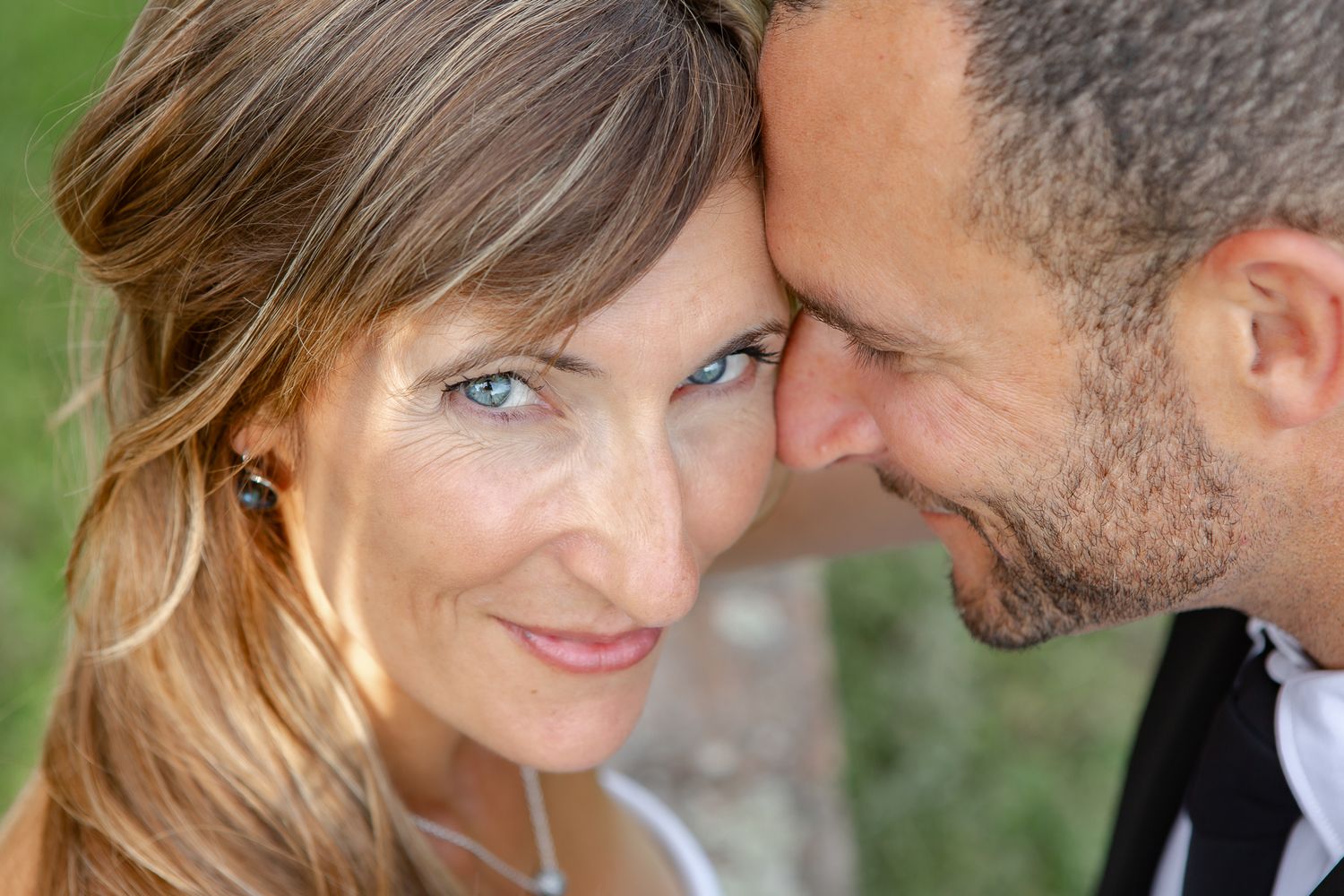 A series of intimate romantic moments between a couple sharing tender gazes and embraces in an outdoor setting.