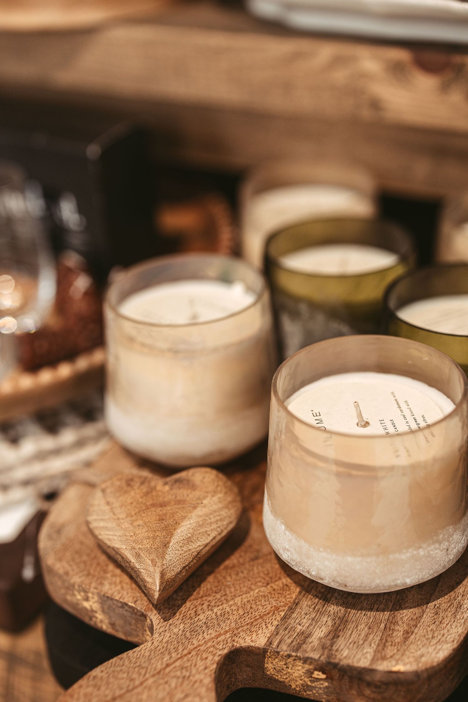 Rustic wooden candle holders with glowing white candles creating cozy ambiance.