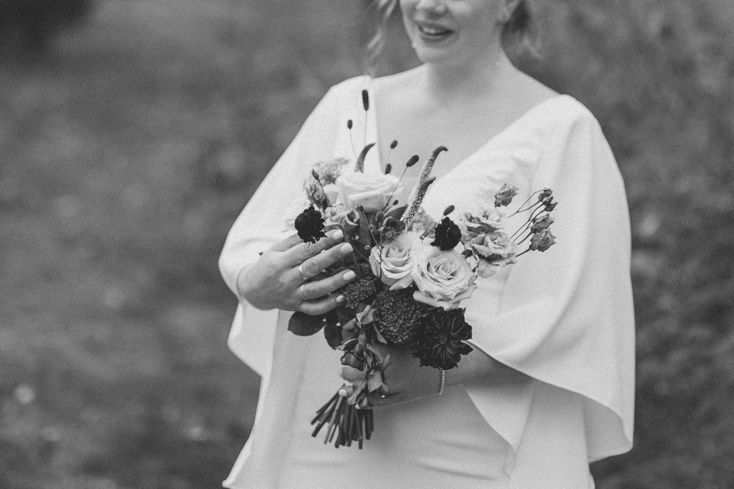 Plan rapproché de la mariée qui tient son bouquet de fleur en autonme
