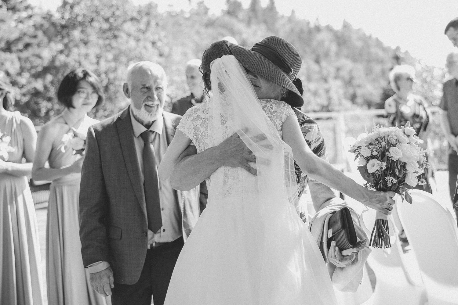 Noir et blanc, les invités qui félicitent la mariée juste après la cérémonie extérieure