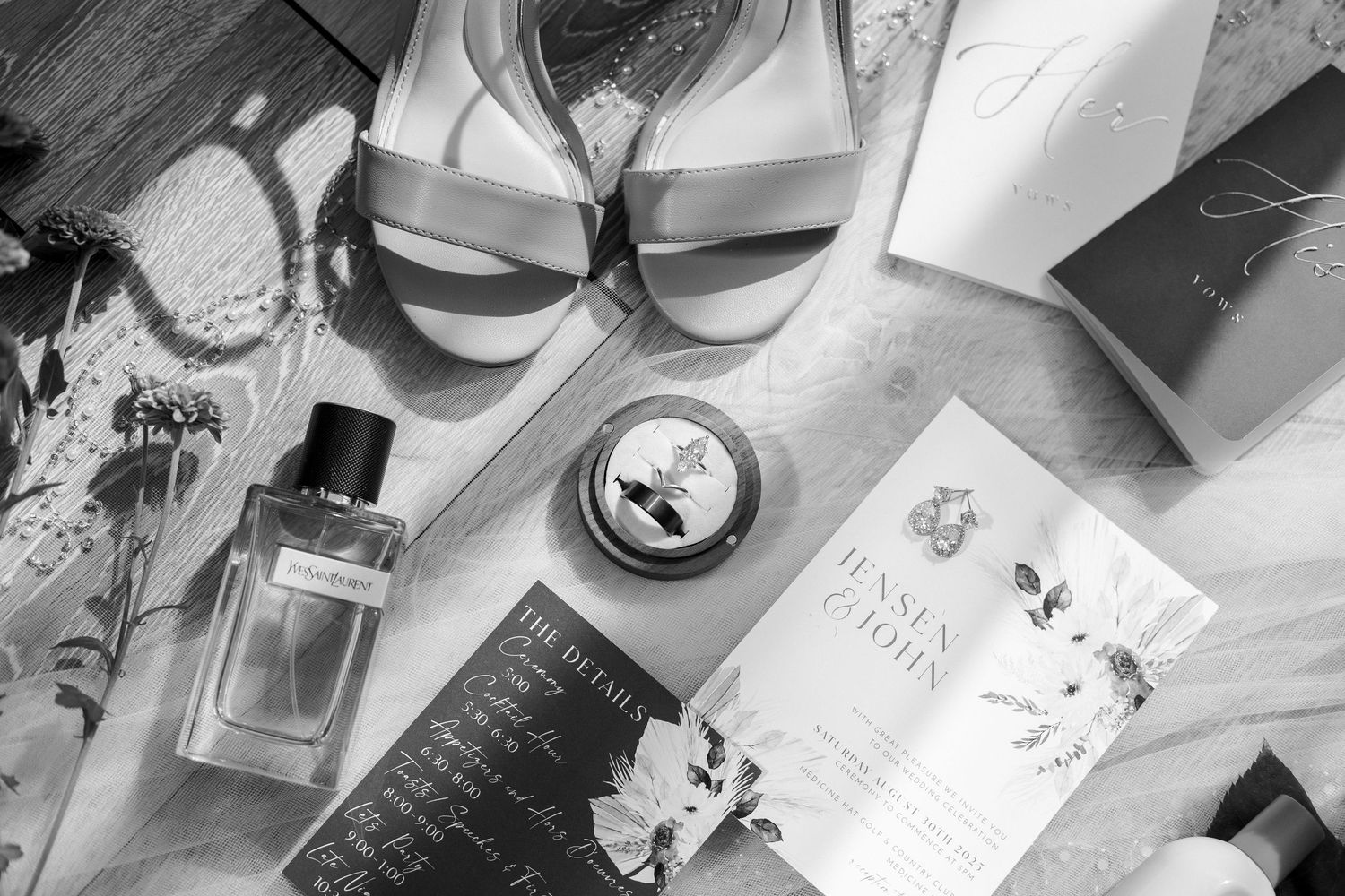 Wedding preparation details including perfume bottles, jewelry, and accessories arranged on a table.