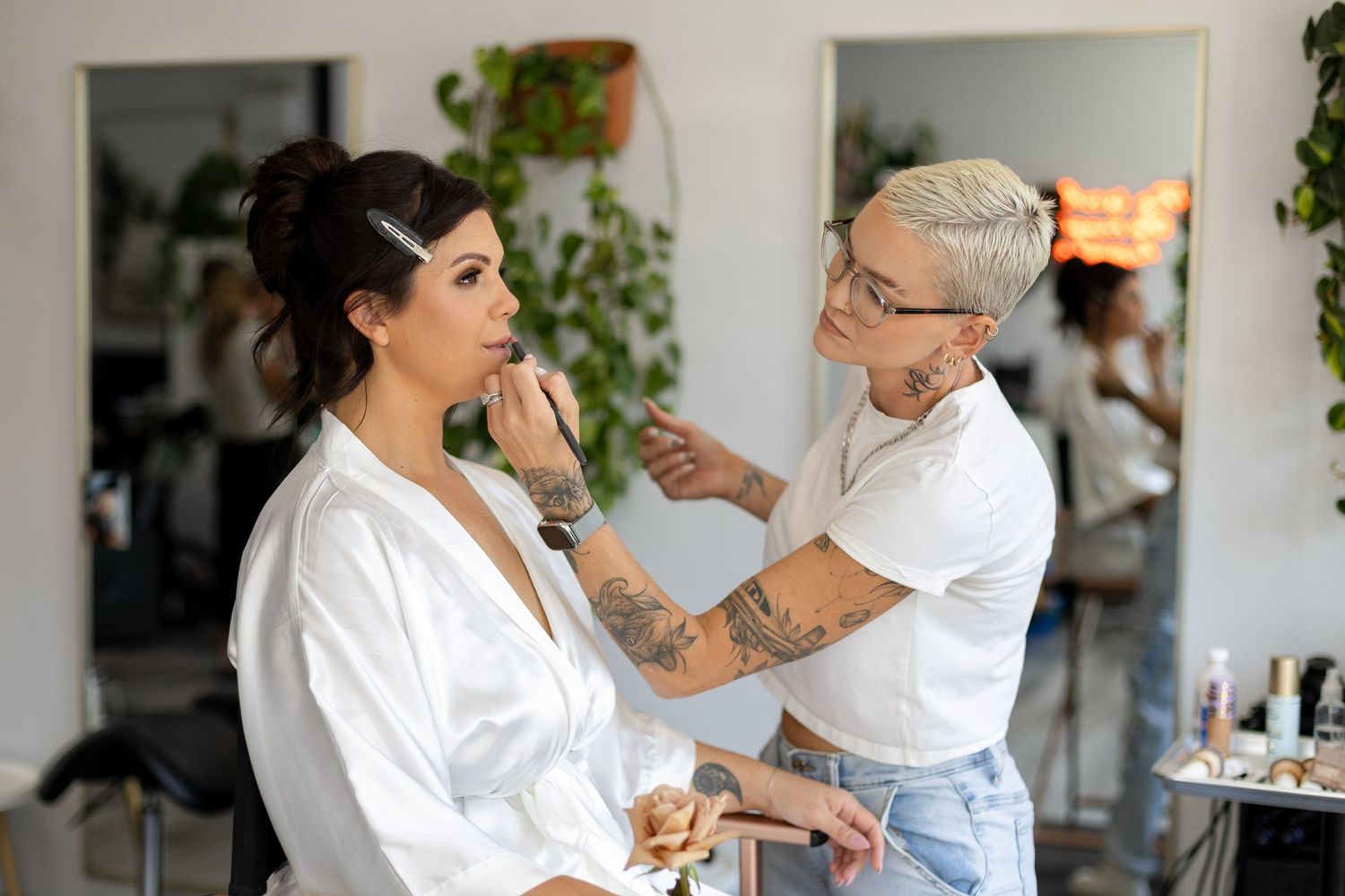 Professional makeup artist applying cosmetics during bridal preparation.