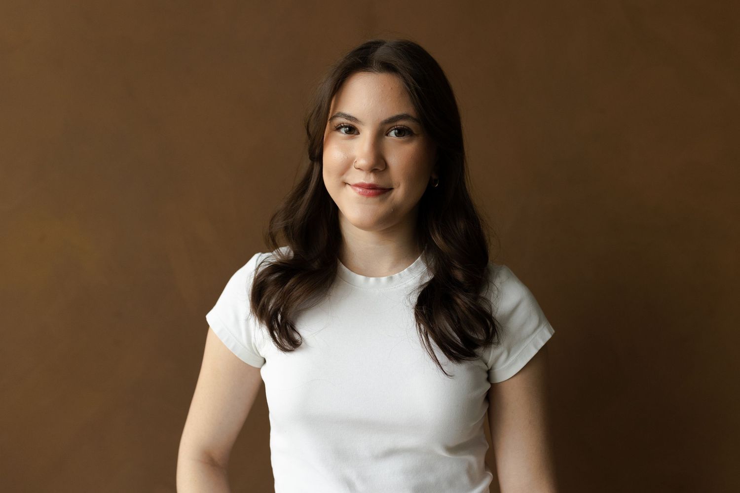 Portrait series against brown backdrop showing casual style.