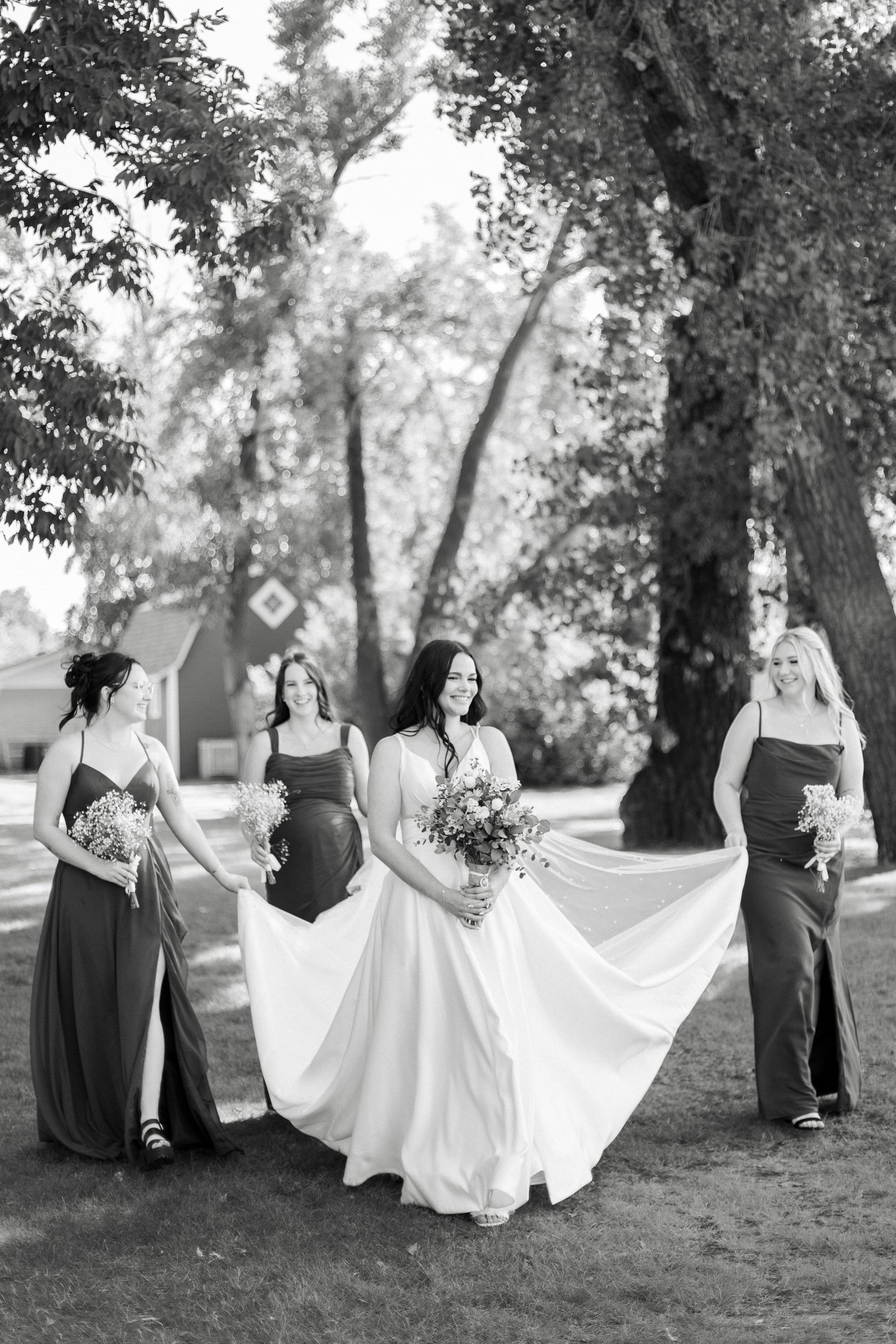 Series of artistic black and white photos showing a bride's flowing dress movement in a wooded outdoor setting.