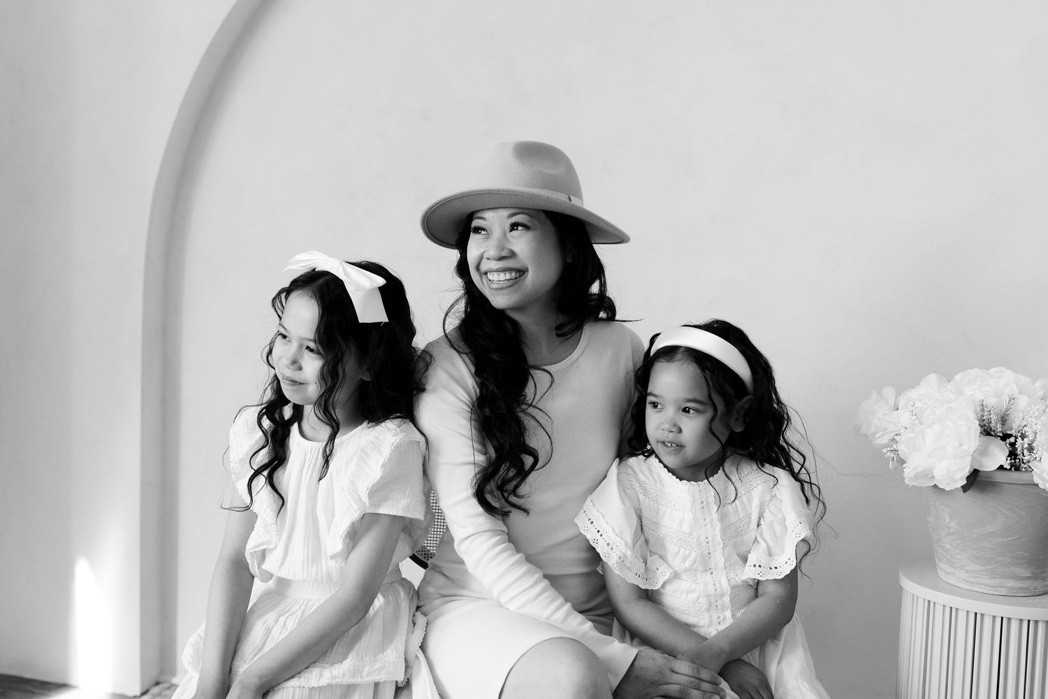 Black and white series of candid family moments with minimalist styling.