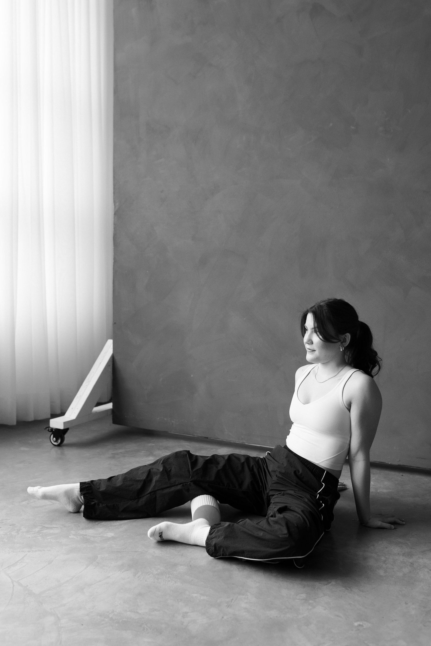 A sequence of black and white photos showing a person lying on the ground in dark clothing.